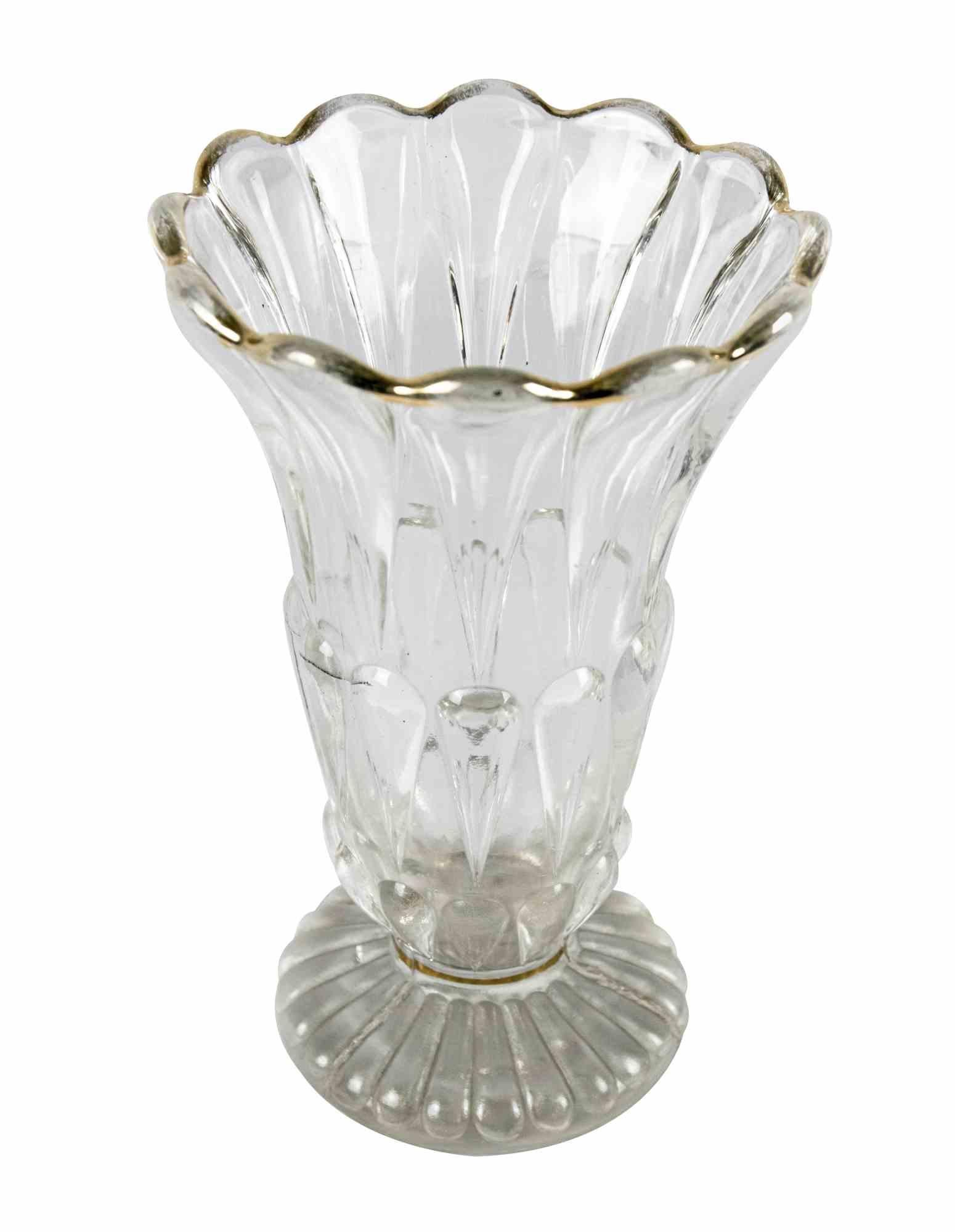 This vintage glass Vase is an original decorative object realized in Italy in the half of the 20th century.

A very elegant glass vase with sinuous decorations on the surface and gilded edge.

Good conditions.