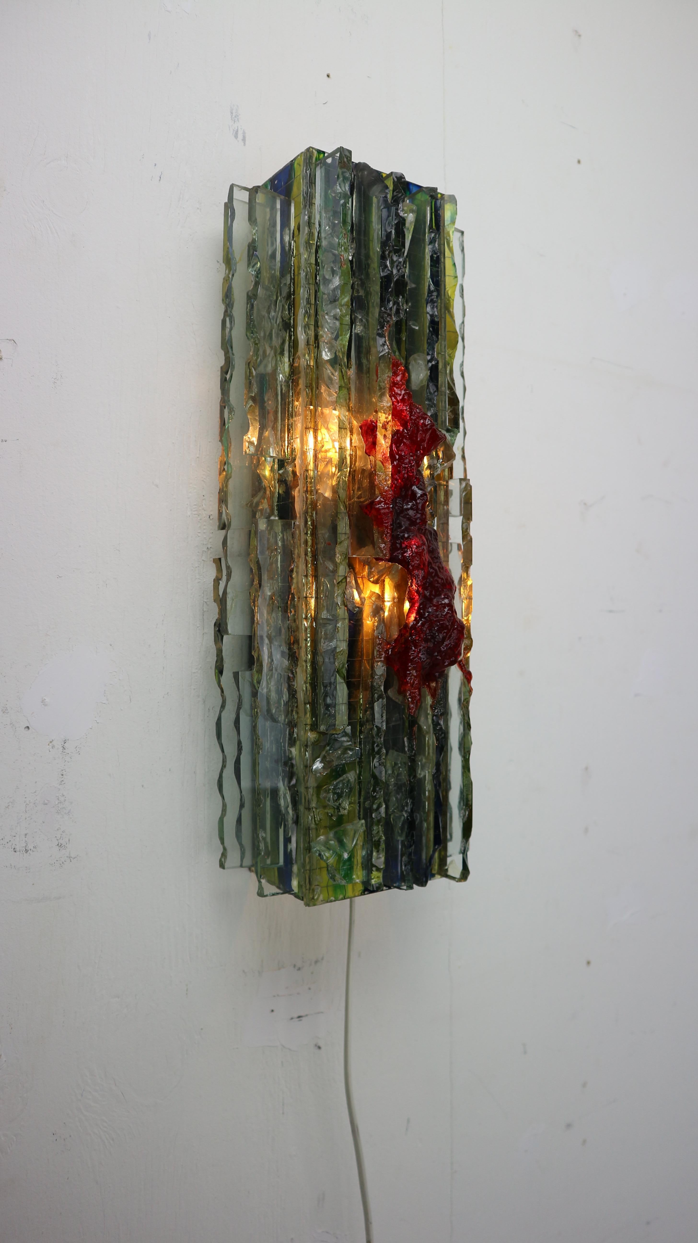 Midcentury wall lamp made from glass by Willen van Oyen Sr. for RAAK Amsterdam in 1960s Netherlands. 
Handmade glass art work, with two light balls to use witch gives beautiful warm lightening and at the same time Brutalist art peace on your