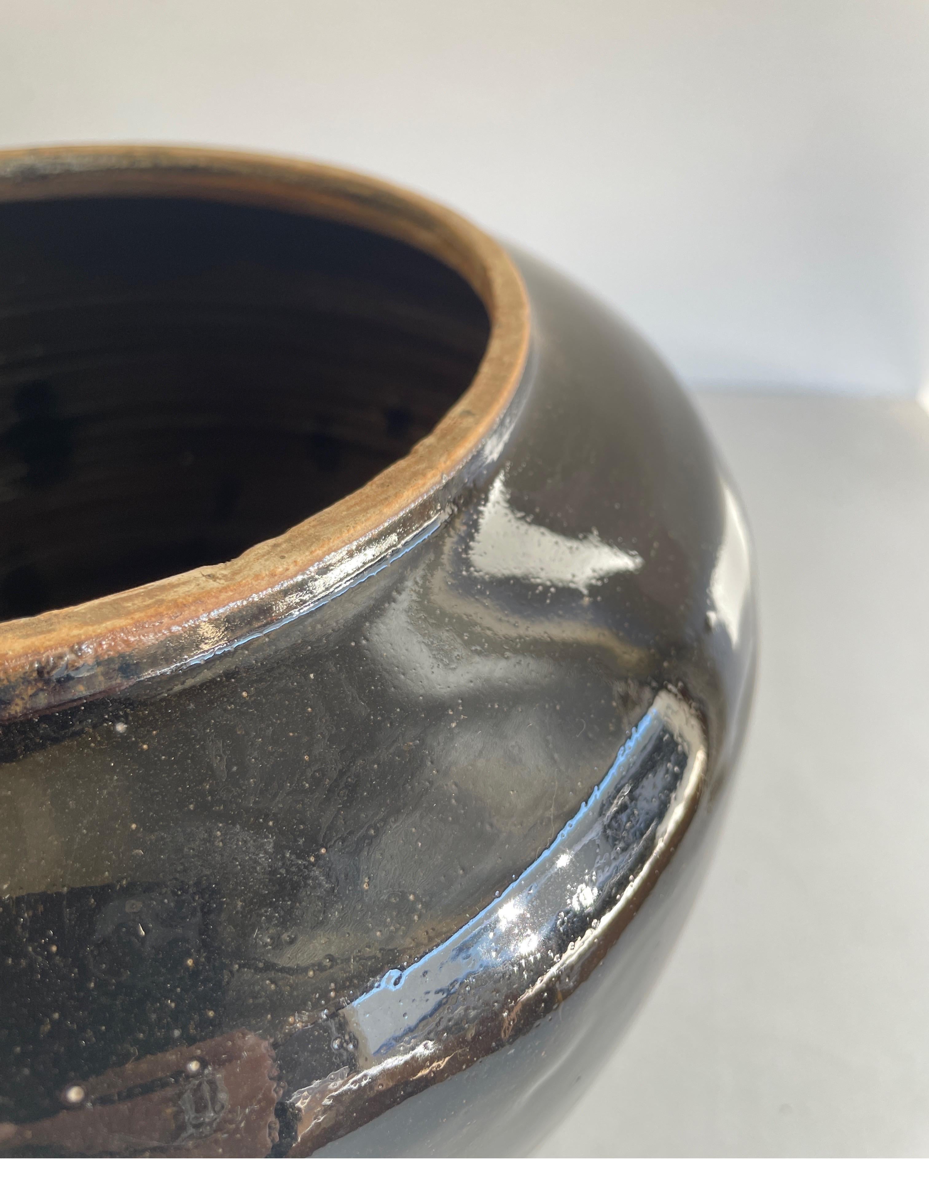 Vintage pottery beautiful and rich in character, this vintage oil pot adds just the right amount of texture + warmth where you need it. Stunning faded black/ brown unglazed finish with warm terra-cotta accents. Some have a more faded appearance than