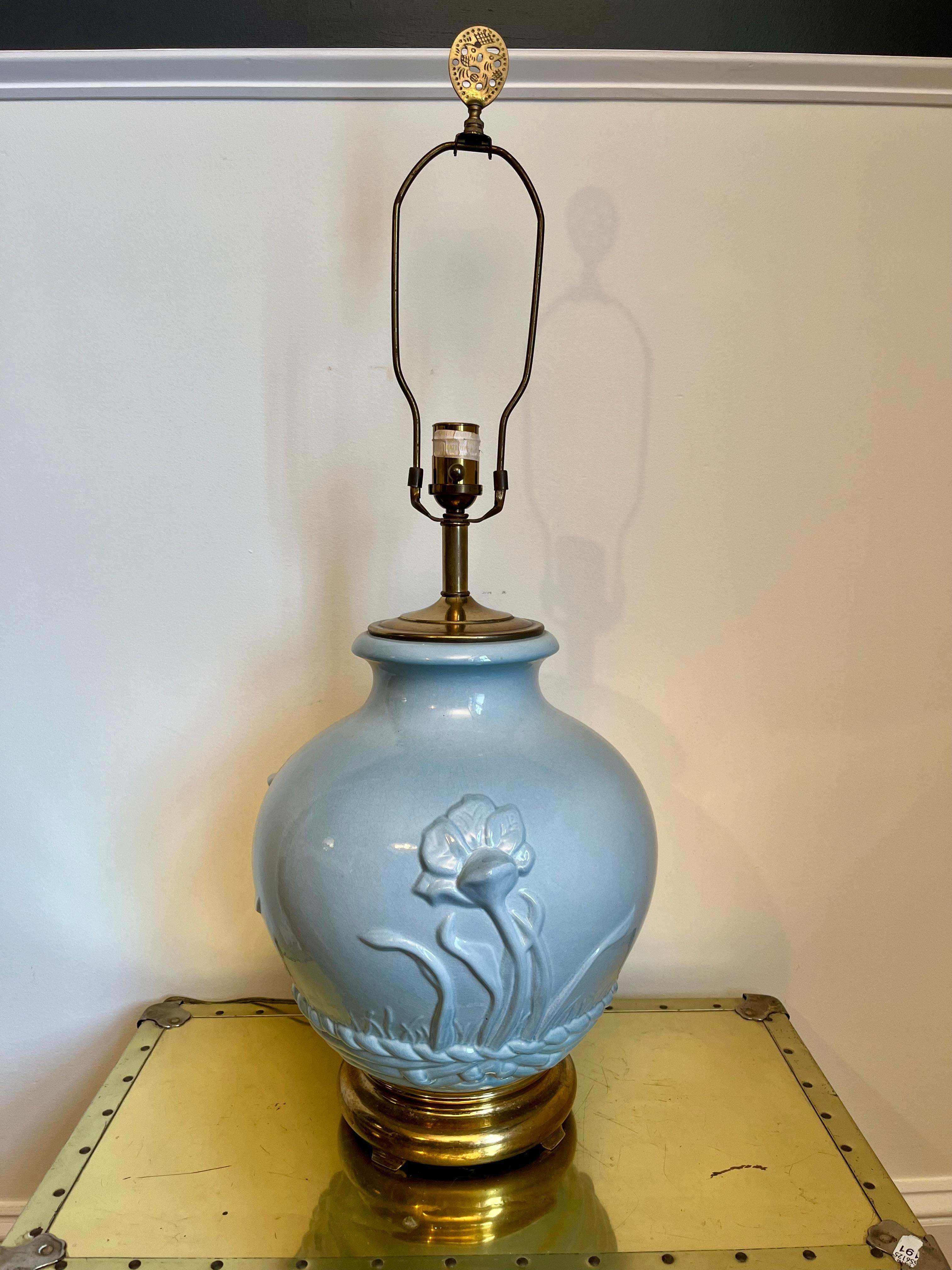 Beautiful simplistic style. Glazed ceramic lotus lamp set atop a brass footed base. Nice presence with a deep aqua color. 3 nicely raised lotus flowers surround.