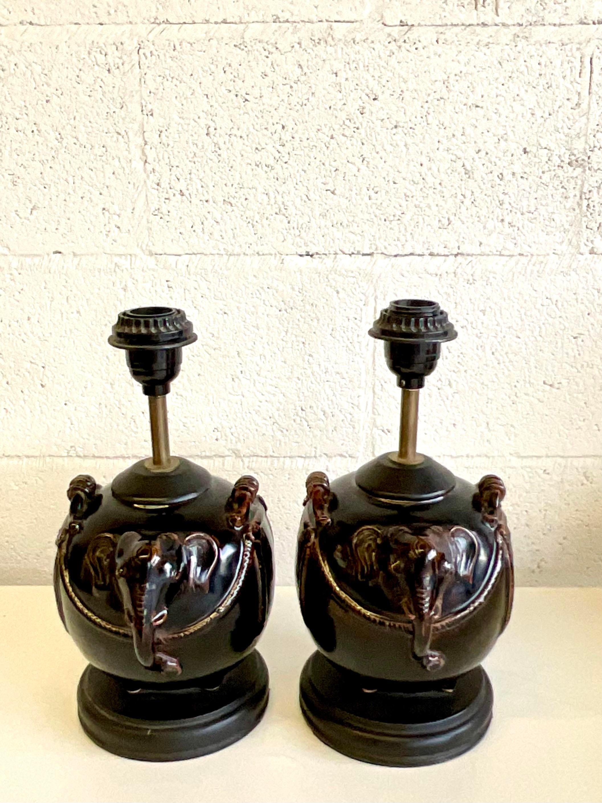 Fantastic pair of vintage glazed ceramic lamps. A charming elephant design in a deep rich brown. Acquired from a Palm Beach estate.