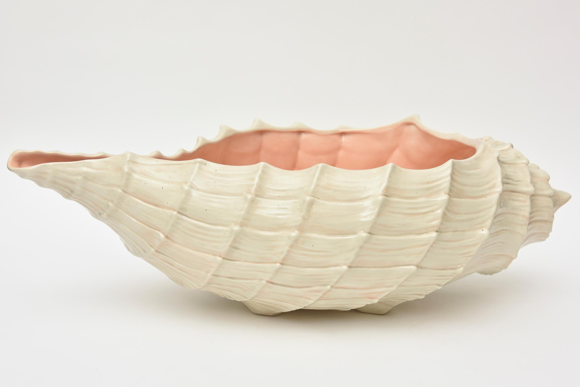 This lovely and monumental oversized vintage glazed organic modern ceramic shell and textural bowl makes a statement. It could be used as a gorgeous centerpiece or for serving. This has a multitude of purposes and uses. The raised detail and texture