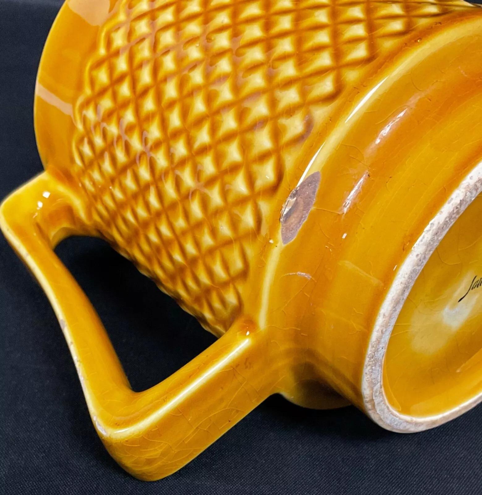 This vintage ceramic pitcher by Digoin Sarreguemines is a beautifully crafted piece that showcases traditional French ceramic artistry. Measuring 6.1 inches (15.5 cm) in height, 4.3 inches (11 cm) in diameter, and 6.5 inches (16.5 cm) in length,