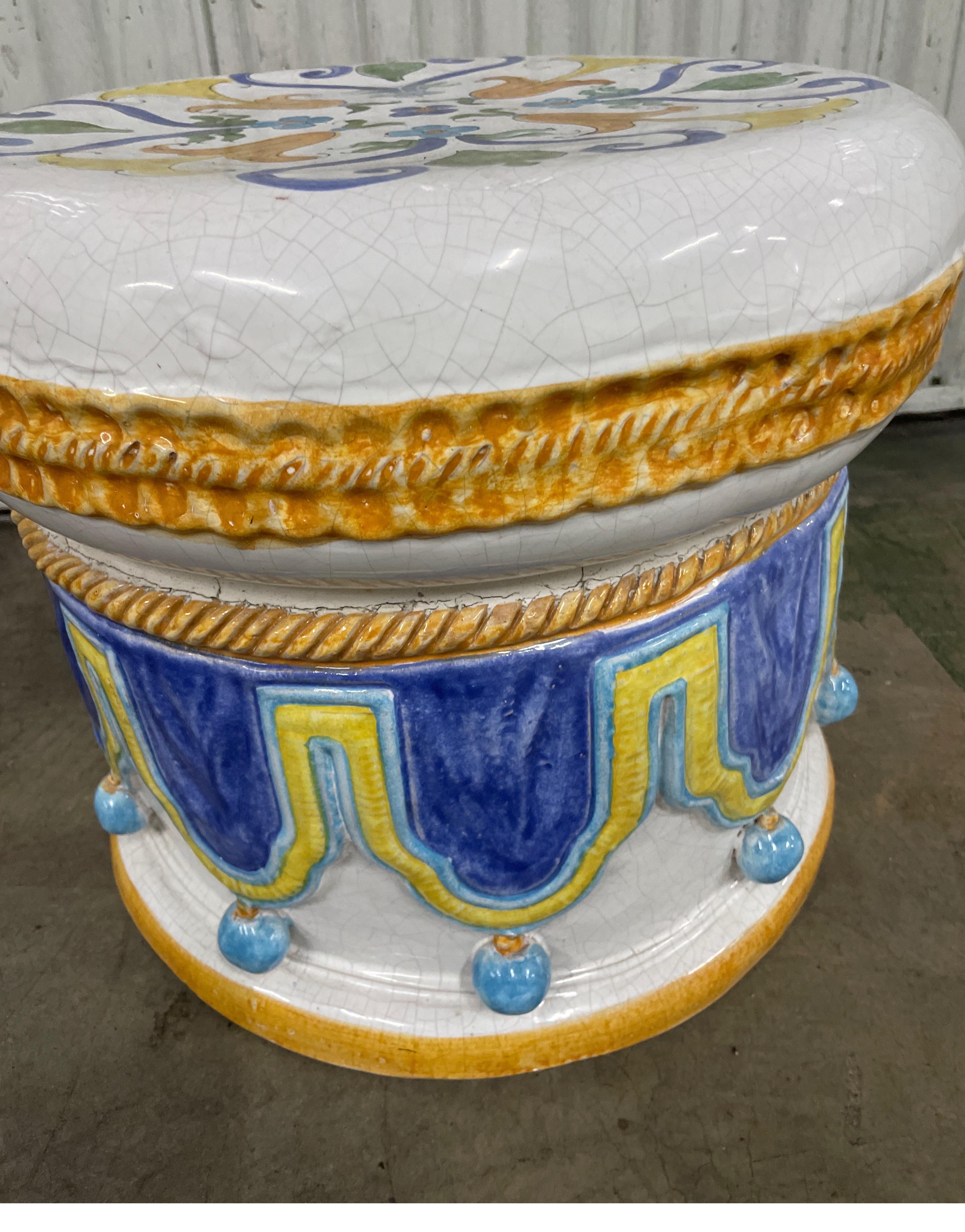 Vintage Italian glazed Terra Cotta round garden seat. Hand painted top and sides with swags, ropes and balls. Very colorful & unique majolica piece.