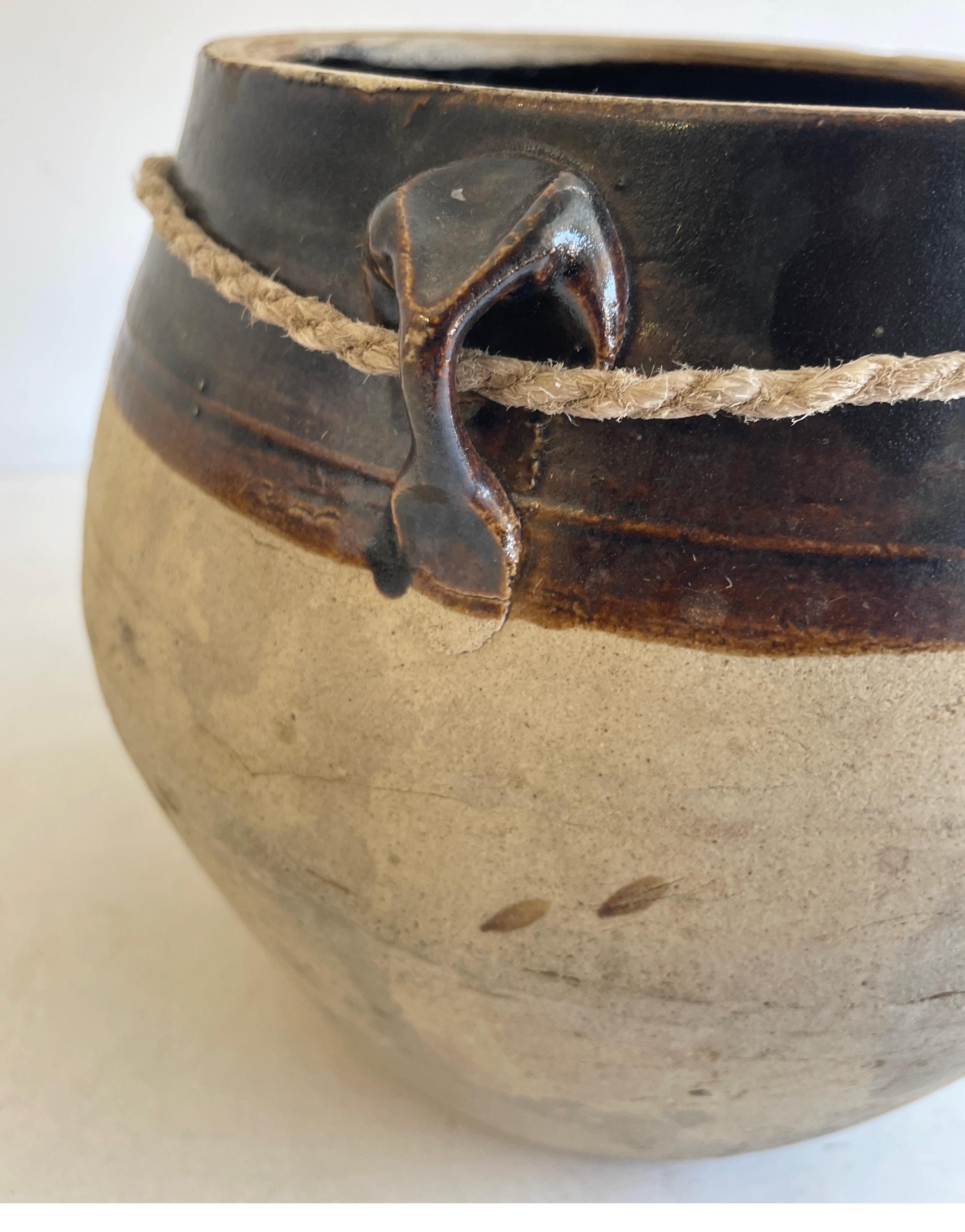 Vintage Pottery Beautiful and rich in character, this vintage oil pot adds just the right amount of texture + warmth where you need it. Stunning faded black/ brown unglazed finish with warm terra-cotta accents. Some have a more faded appearance than