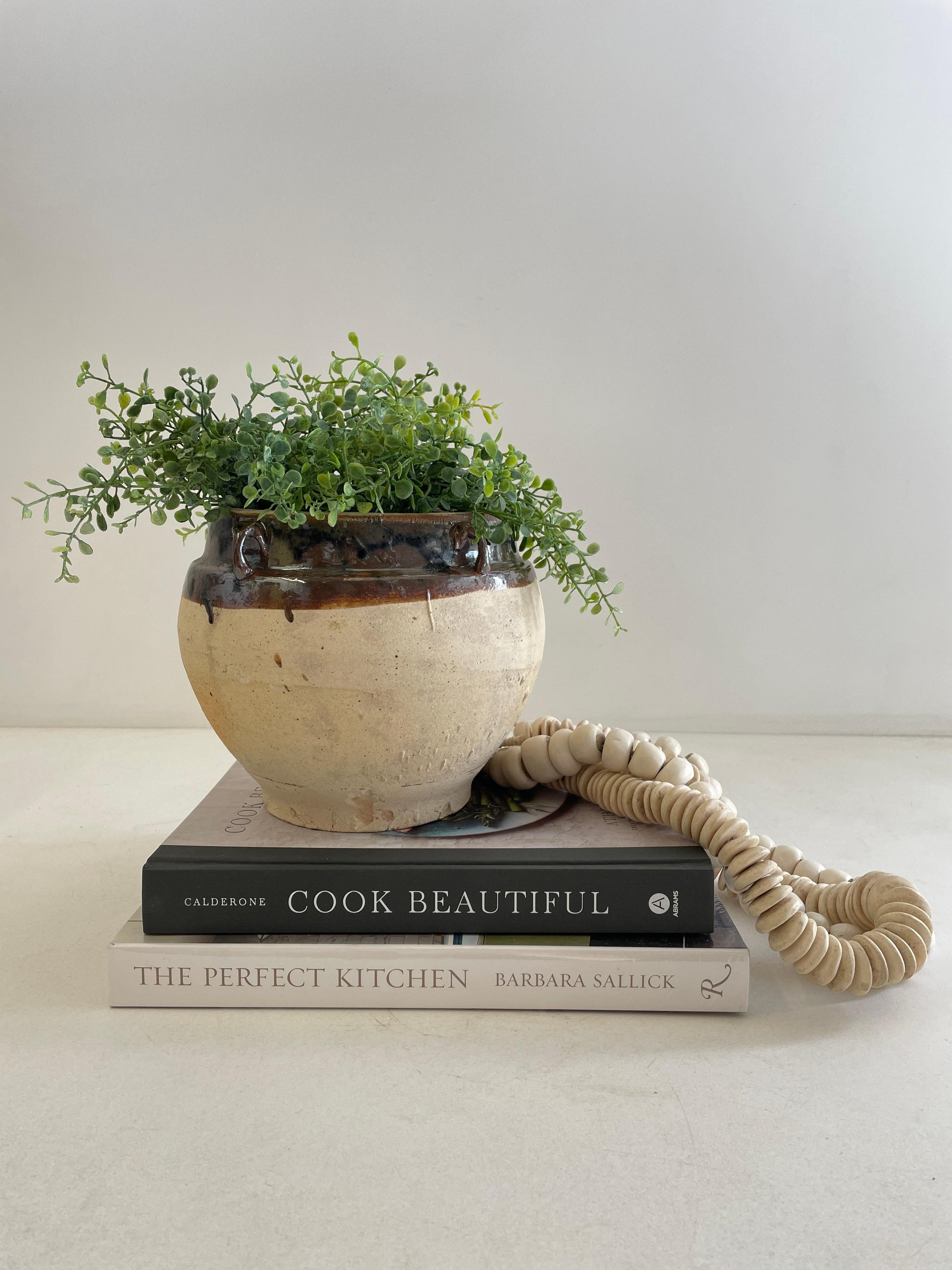 Vintage glazed pottery
Beautifully glazed and rich in character, this vintage glazed oil pot adds just the right amount of texture + warmth where you need it. Stunning glazed finish with warm terra-cotta accents.
Coloring is an olive green, dark