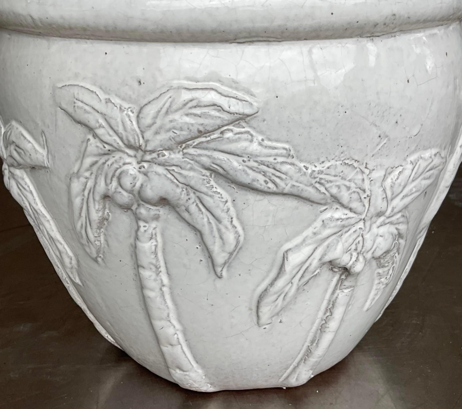 Bring a touch of tropical charm to your space with this pair of Vintage Glazed Terra Cotta Palm Tree Planters. Featuring a classic American style, their vibrant glaze and palm tree motif add a stylish, coastal flair to any indoor or outdoor setting.