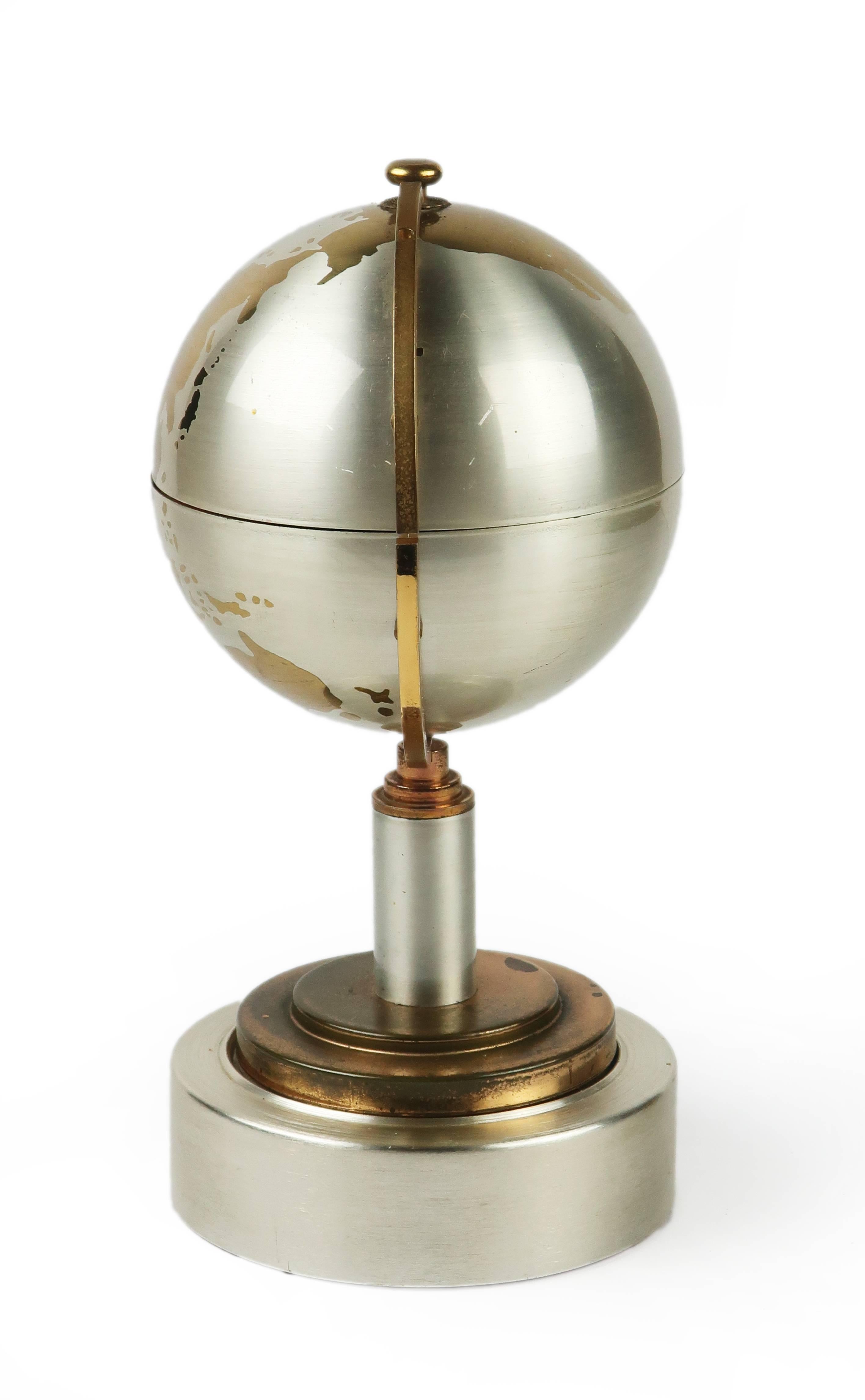 This midcentury cigarette holder comes in the very clever form of an expandable globe. In chrome, brass, and plastic, the top half of this globe can be extended 6” to hold almost a full pack of cigarettes.

  
