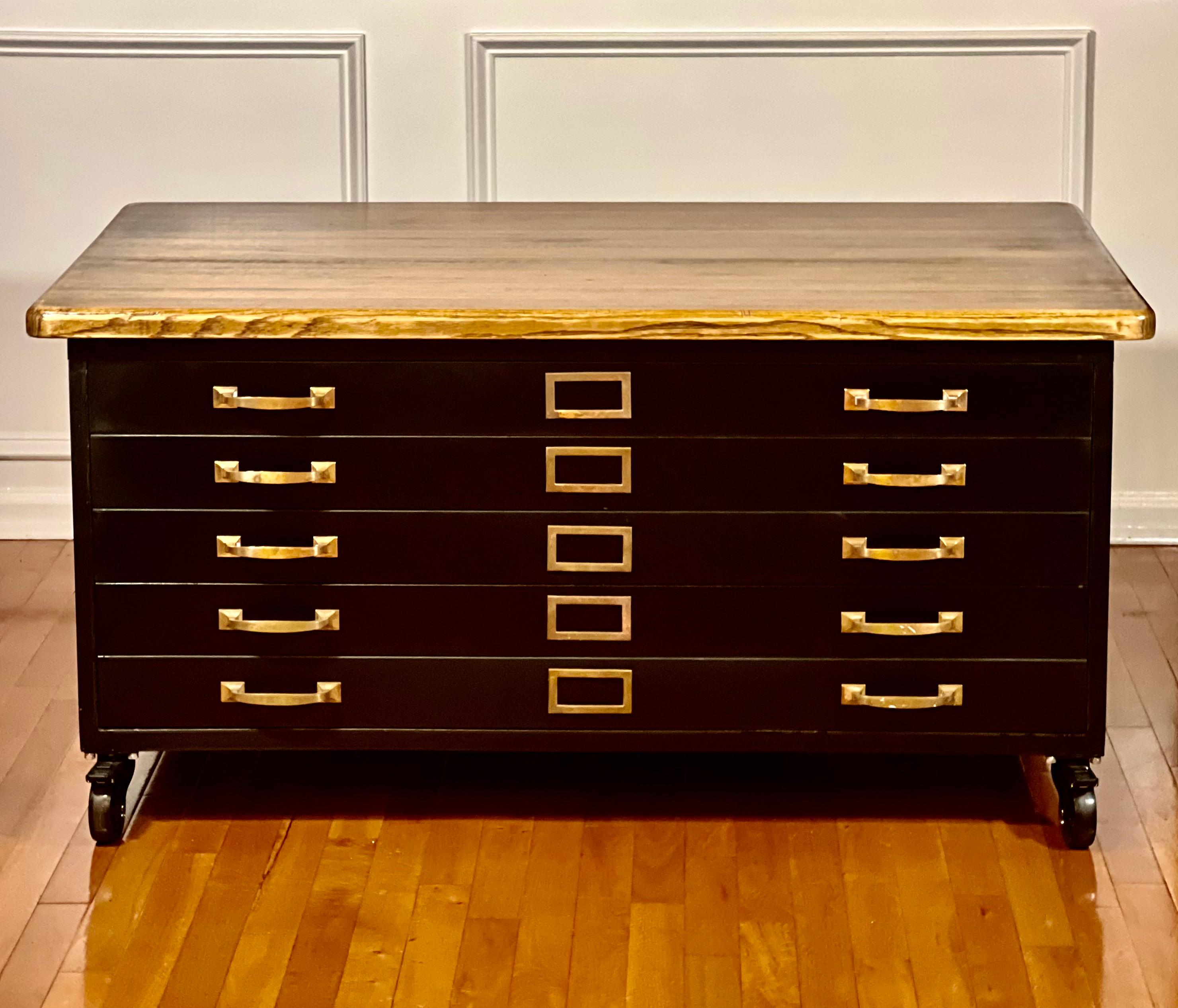 Vintage Globe Wernicke flat file cabinet, 1940's.

A steel architect's flat file cabinet repurposed for use as a coffee table. It has been refinished in black with the addition of a unique, reclaimed wood top and heavy duty casters with a simple