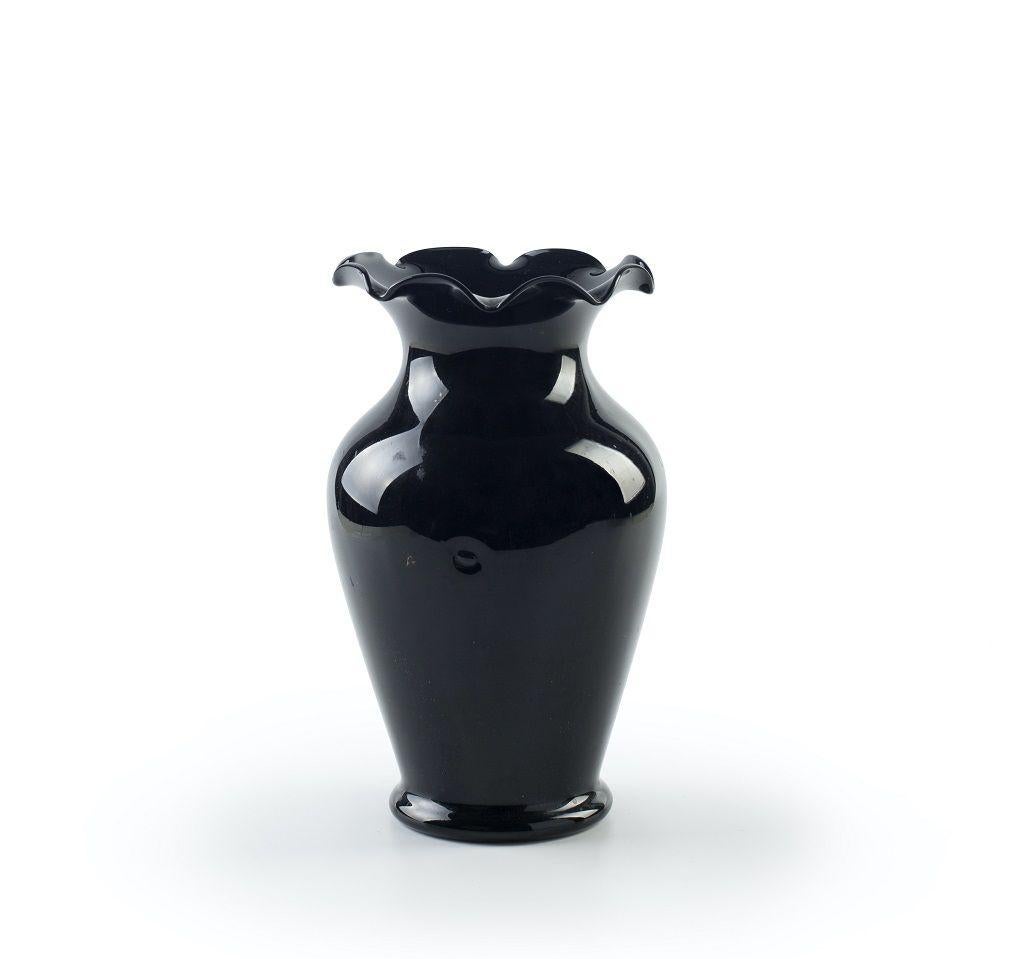 This Vintage Glossy Black Vase, realized in Germany during the 1940s.

Very good condition except for a minor chip.
 