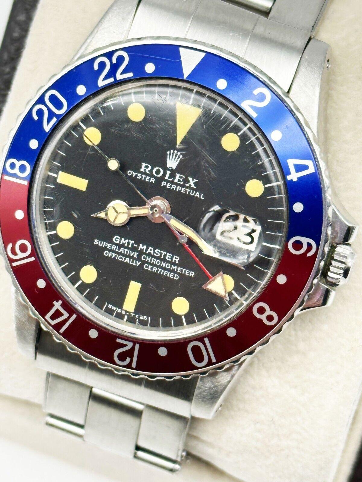 Style Number: 1675

Serial: 3113***

Year: 1972

Model: GMT Master  

Case Material: Stainless Steel  

Band: Stainless Steel 

Bezel:  Pepsi - Red and Blue

Dial: Black

Face: Sapphire Crystal 

Case Size: 40mm 

Includes: 

-Rolex Box &