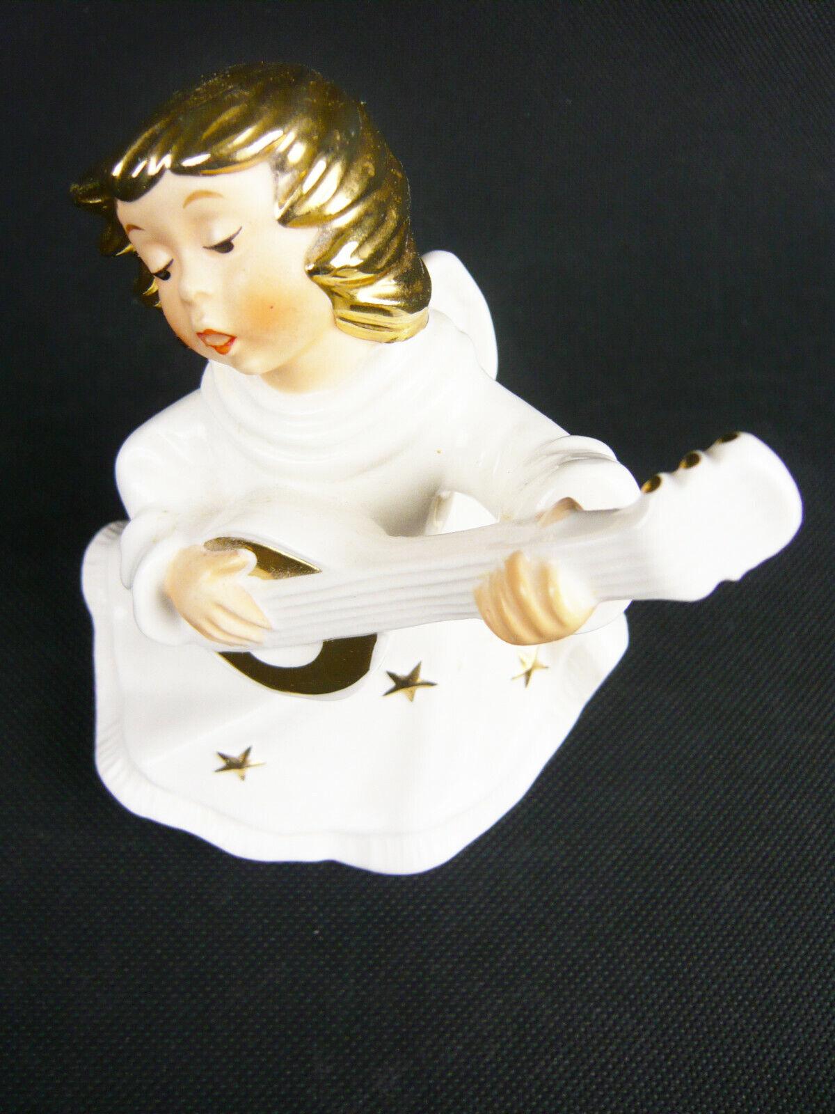 Elevate your decor with the exquisite beauty of this Vintage Goebel Angel with Mandolin candle holder, identified by its unique reference number: 42 447 12. Crafted from Goebel porcelain, this figurine is not just a decorative piece; it's a
