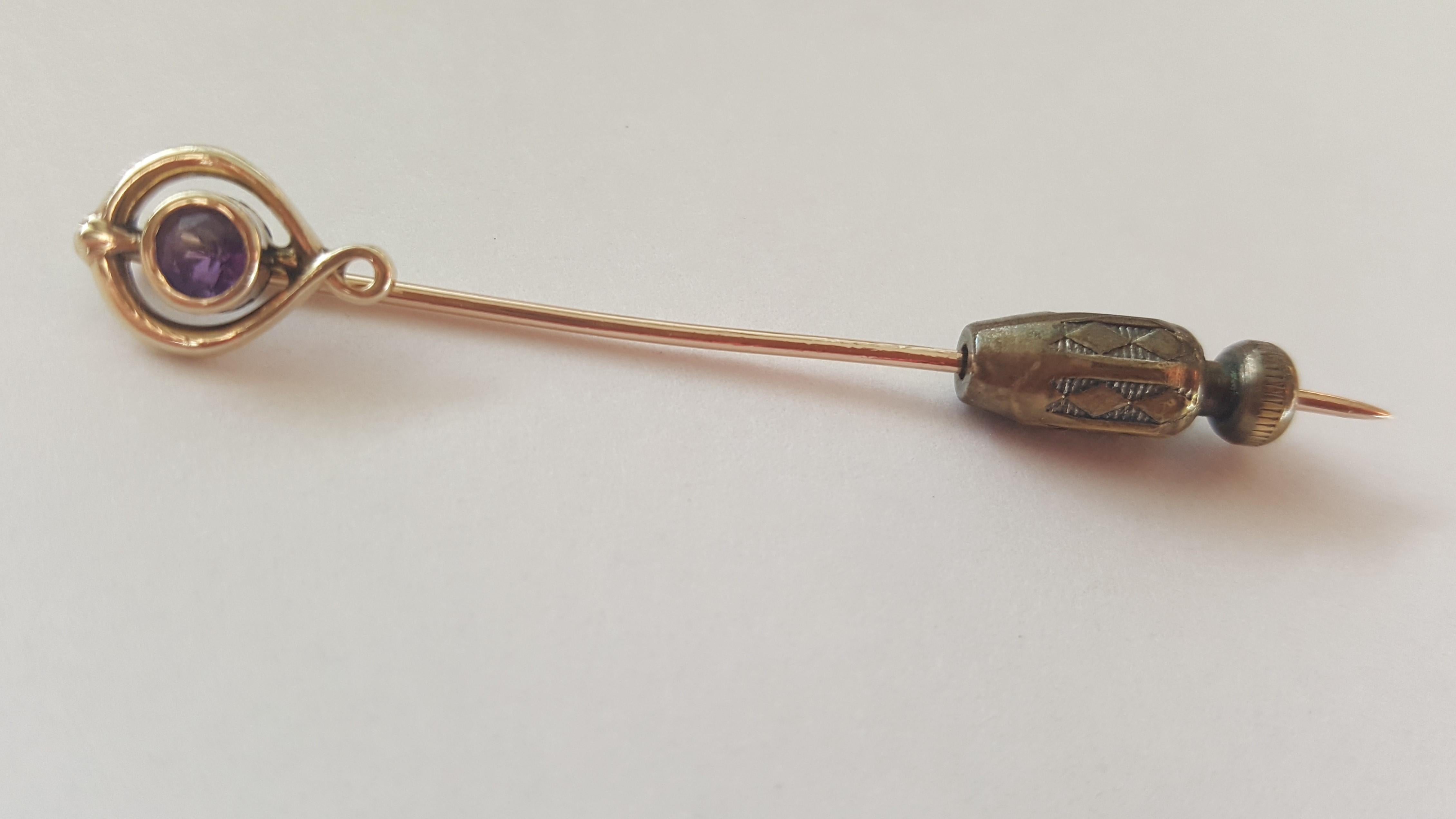 Vintage 10kt yellow gold round bezel-set amethyst stickpin.  The length of the stickpin is 2.25 inches long, weighs 1.1 grams without push-on security (1.6 grams with push-on). The amethyst is bezel set and the diameter of the top of the stickpin is