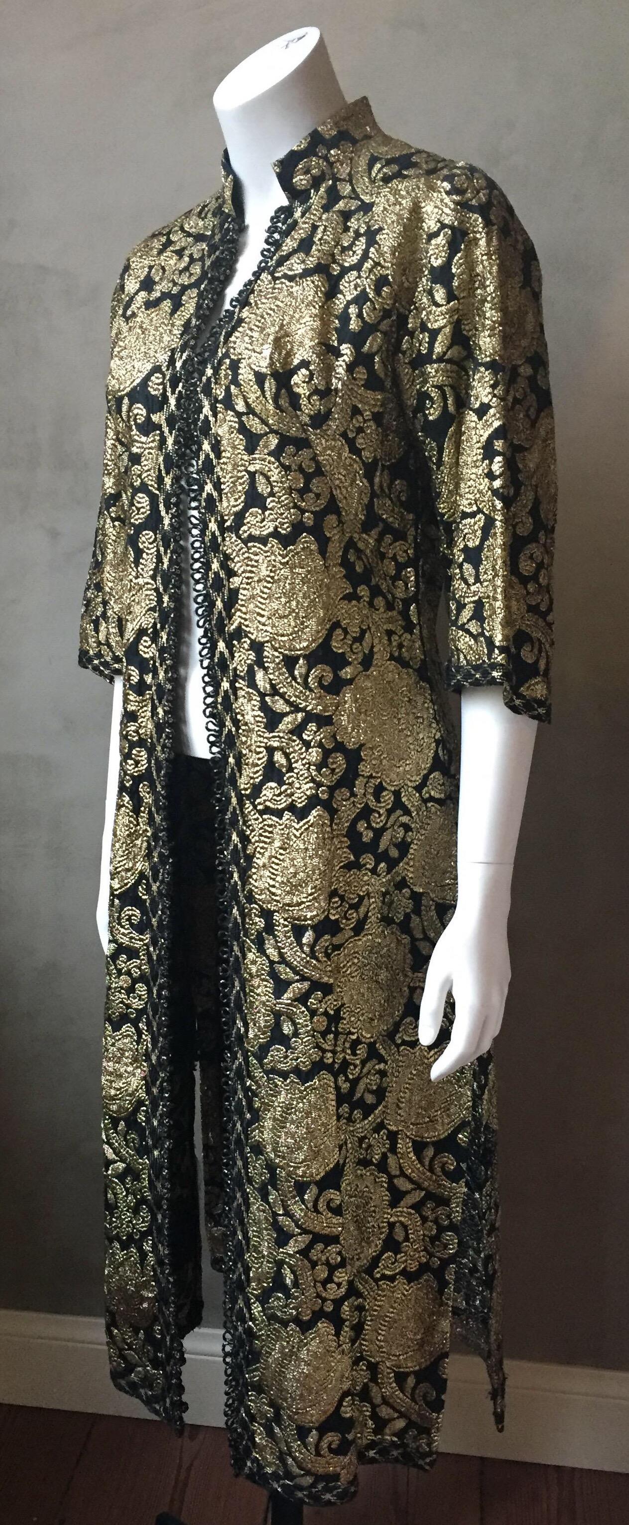 A vintage Turkish style gold and black brocade dress or evening jacket. Tiny knot buttons all the way down the front and a side zipper allow the dress to be worn completely closed when worn as a dress, or button the top half and leave from waist