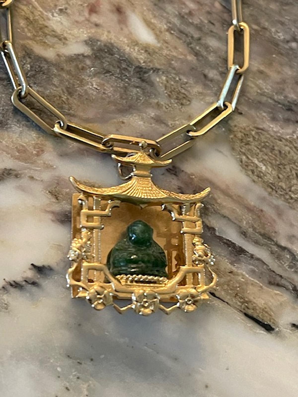 Fabulous estate carved jade buddha charm sitting within a retro 14k yellow gold statement pagoda. This charm is retro and fabulous. A zen buddha for good luck and prosperity. Can be engraved on the large plain back. Hang it as a medallion on a long