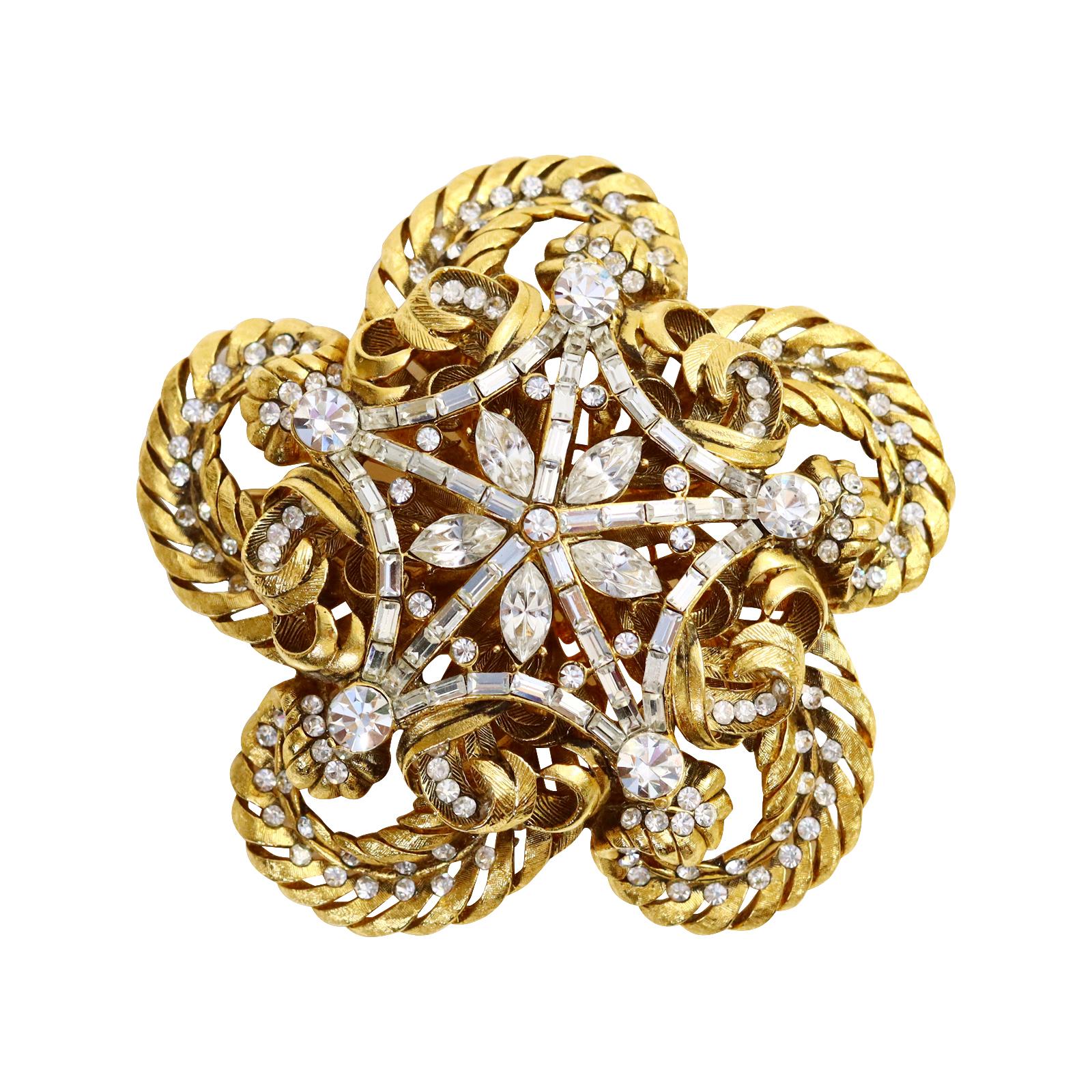 Vintage Gold and Crystal Domed Large Brooch Circa 1980s.  Intricate Gold design work shows baguettes and oval stones sitting on top in a star like pattern. Looks great as a brooch but also on a silk cord or a thick gold link chain or a black lariat.