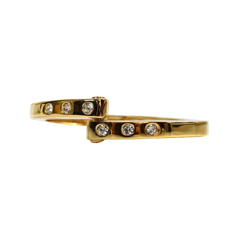 Vintage Gold and Diamante Clamper Bracelet Circa 1990s. This bracelet is so well made.  It has 3 channel set cz's on either side and is then shown with one side on top of the other.  Worn with Gold, Silver, Enamel or even string bracelets or even