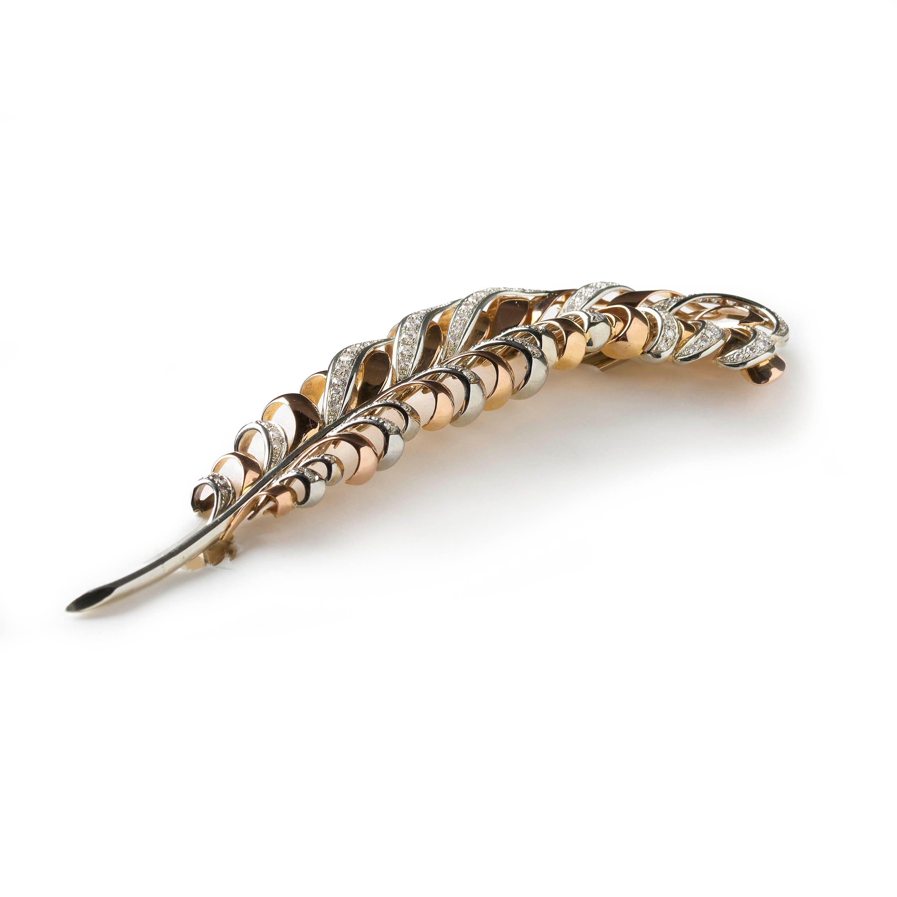 A vintage gold and diamond feather brooch, with brilliant-cut and single-cut diamonds set within white gold plumage, weighing an estimated total of 3.50 carats, all mounted in 18ct gold. Circa 1950. 