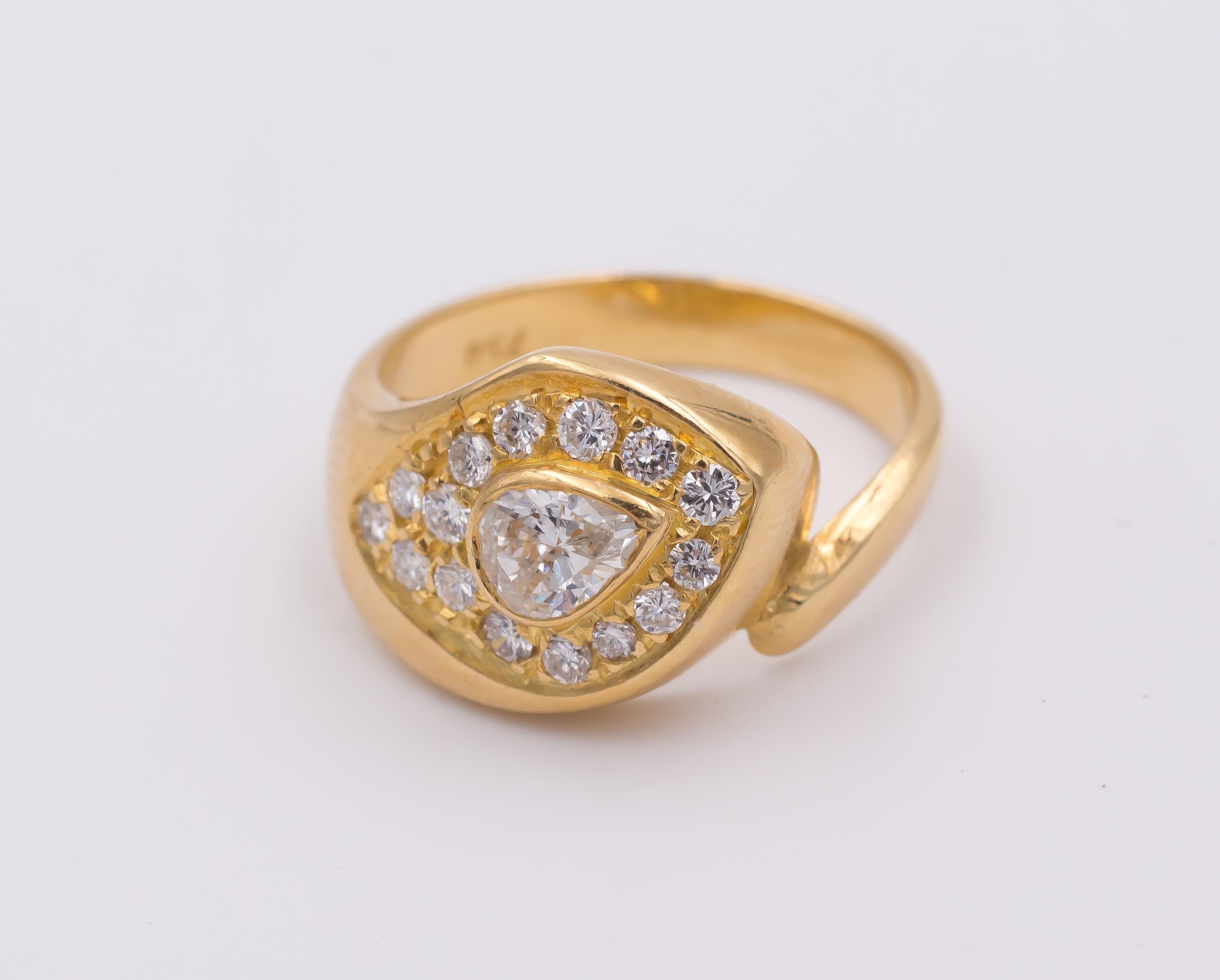 This beautiful vintage snake ring is crafted in yellow gold throughout and dates from the 1970s. It is set with a central diamond, surrounded by sixteen diamonds.  

MATERIALS
Gold and diamonds

RING SIZE
6½ US (resizable)