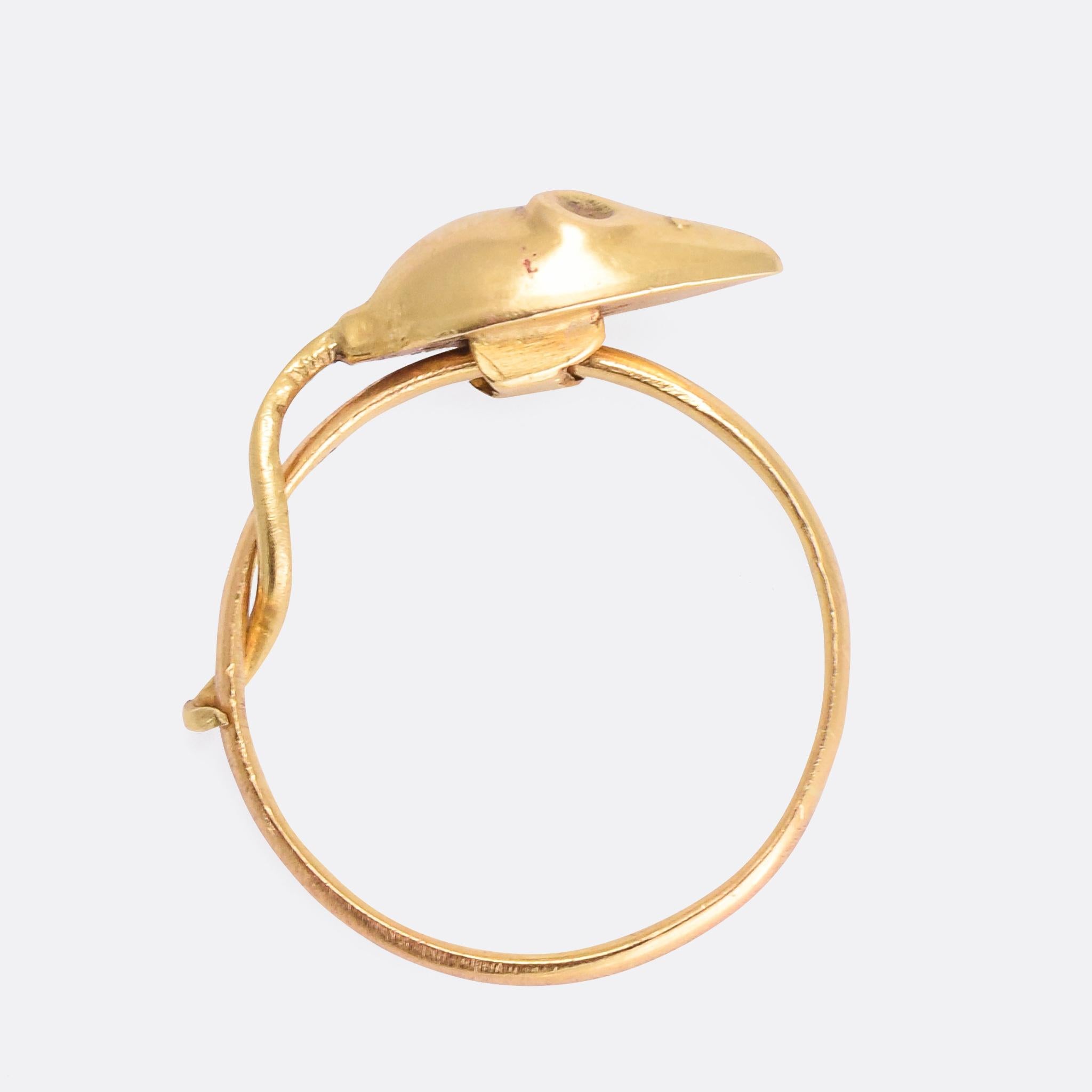 An incredibly cute vintage ring featuring a mouse that moves freely around the band, with its tail looped around it as if keeping its balance. It dates from the 1950s, the mouse having been added to an earlier 22k wedding band (likely dating from