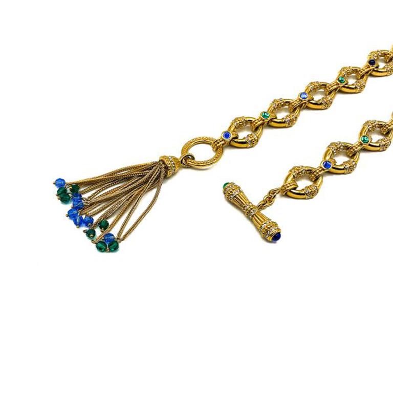 A striking Vintage Jewelled Tassel Sautoir. Crafted in high quality gold plated metal set with cabochon and faceted green and blue glass stones with clear rhinestone chaton accents. Featuring intricate craftsmanship throughout the necklace is