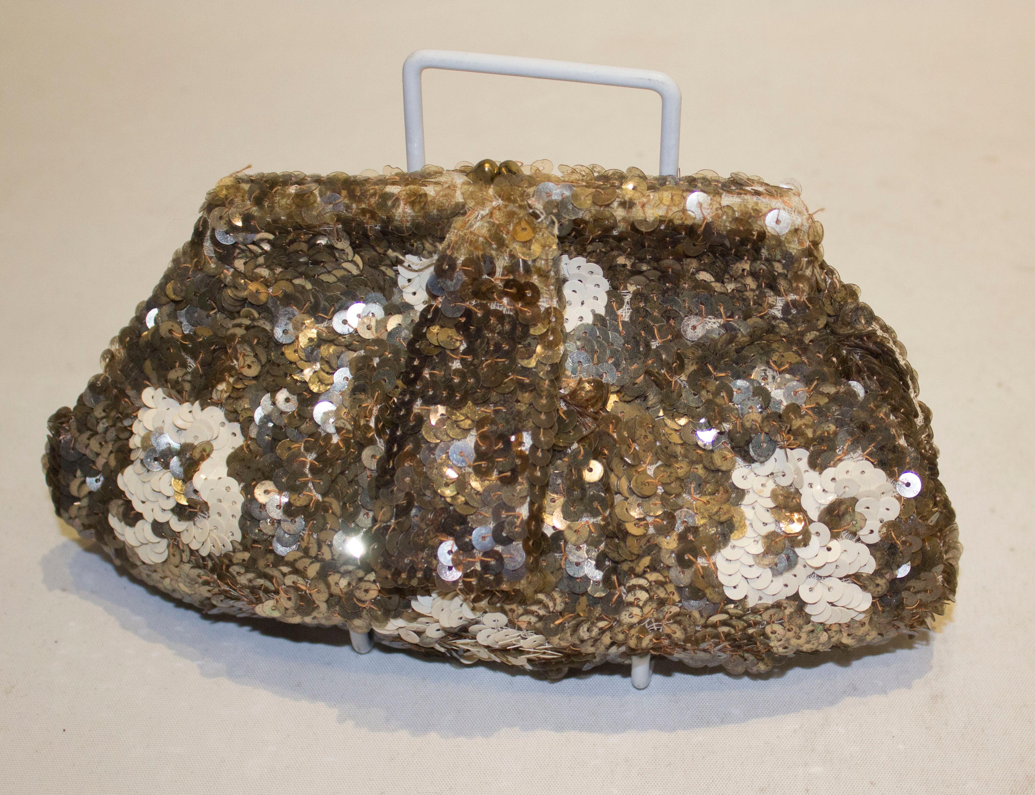 A great vintage sequin evening purse in gold, bronze and cream. The purse is lined in satin with one pouch pocket. Measurements: width 8'', height 5''