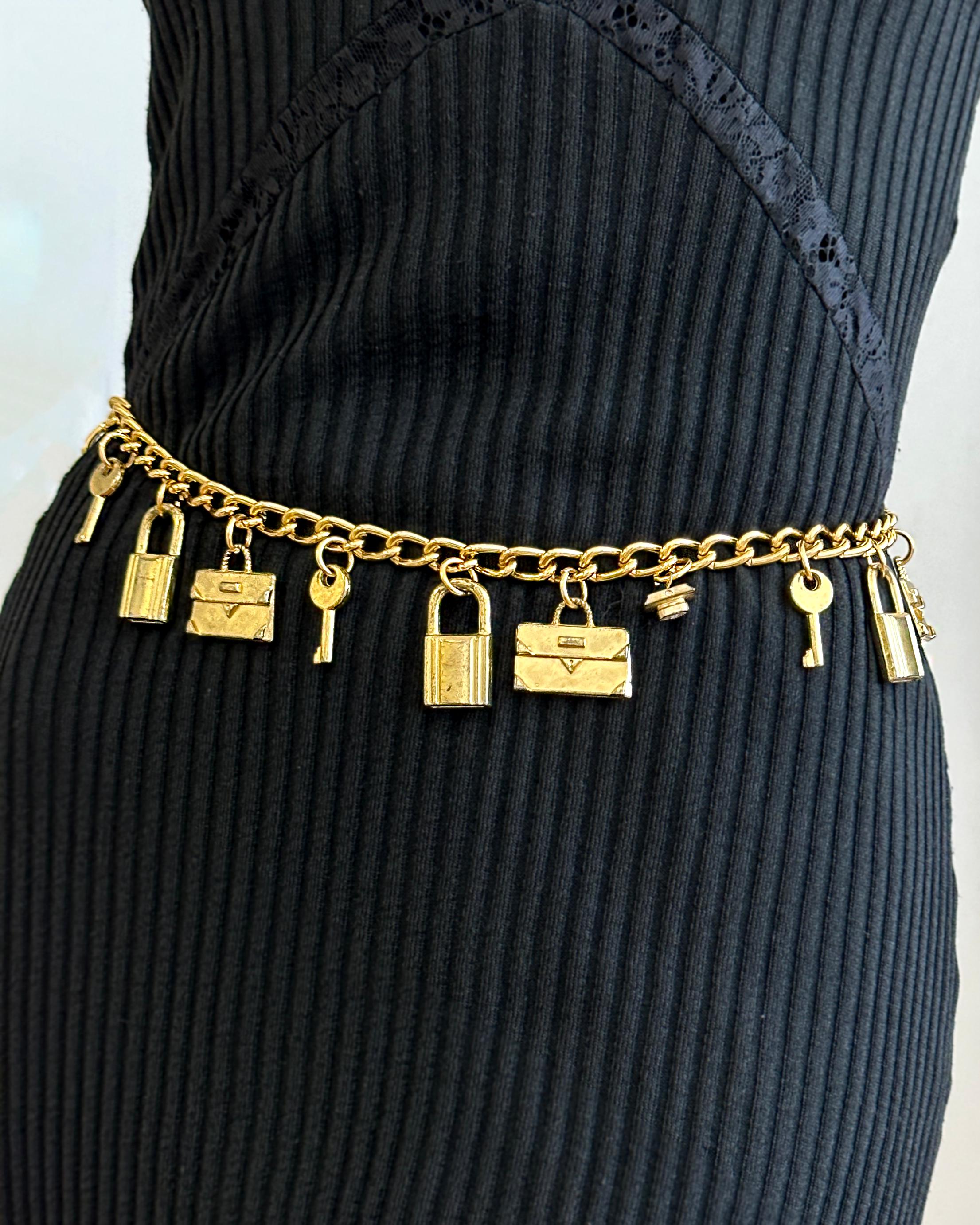 VERY BREEZY presents: This vintage chain belt feels straight off a 90s Chanel runway; it's really unlike any other I've seen. It features charms including locks, keys, and letters. The gold-tone chain is substantial and a great color. The hook clasp