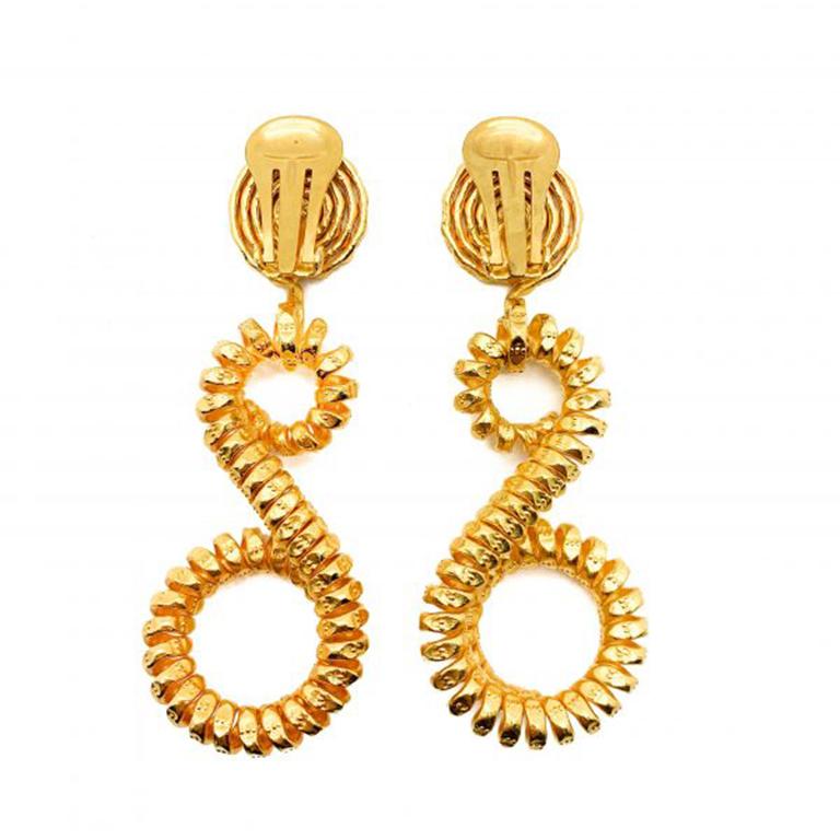 Impresionantes pendientes vintage en espiral de los años 90. Con elaboradas puntas y gotas de metal en espiral, chapadas en oro de 18 ct para un aspecto verdaderamente lujoso. En muy buen estado vintage, mide aprox. 7 cm y tiene enganches de clip.