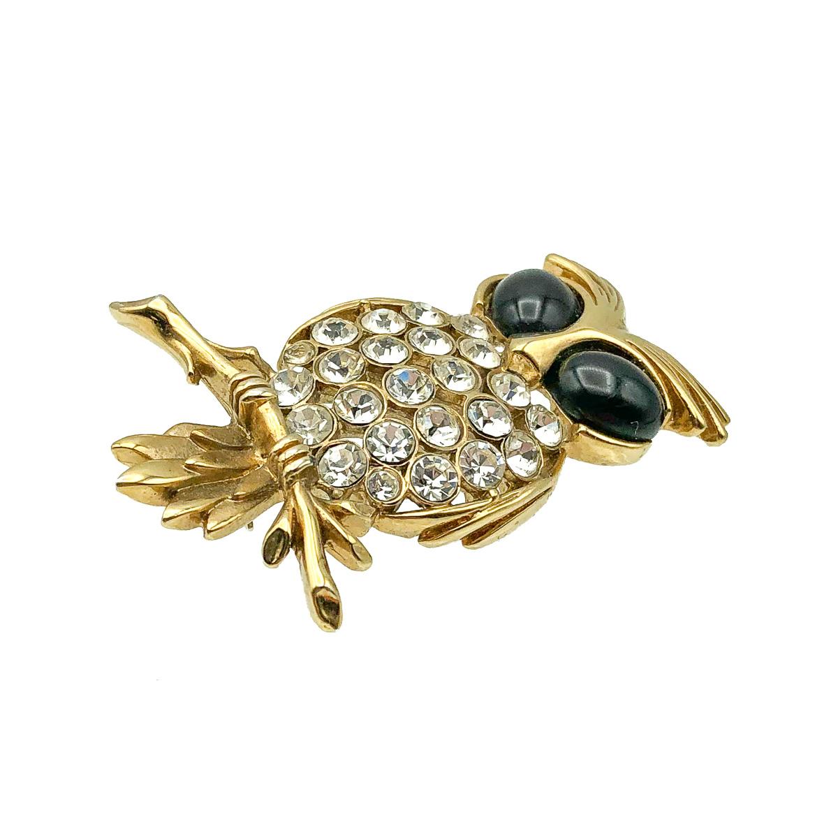 An adorable Vintage Owl Brooch. Featuring an owl on a bough with large stone set eyes and jewelled chest. Crafted in gold plated metal, crystal and glass.  In very good vintage condition. 5cms.  Lovely quality and detailing. A wonderful vintage pin