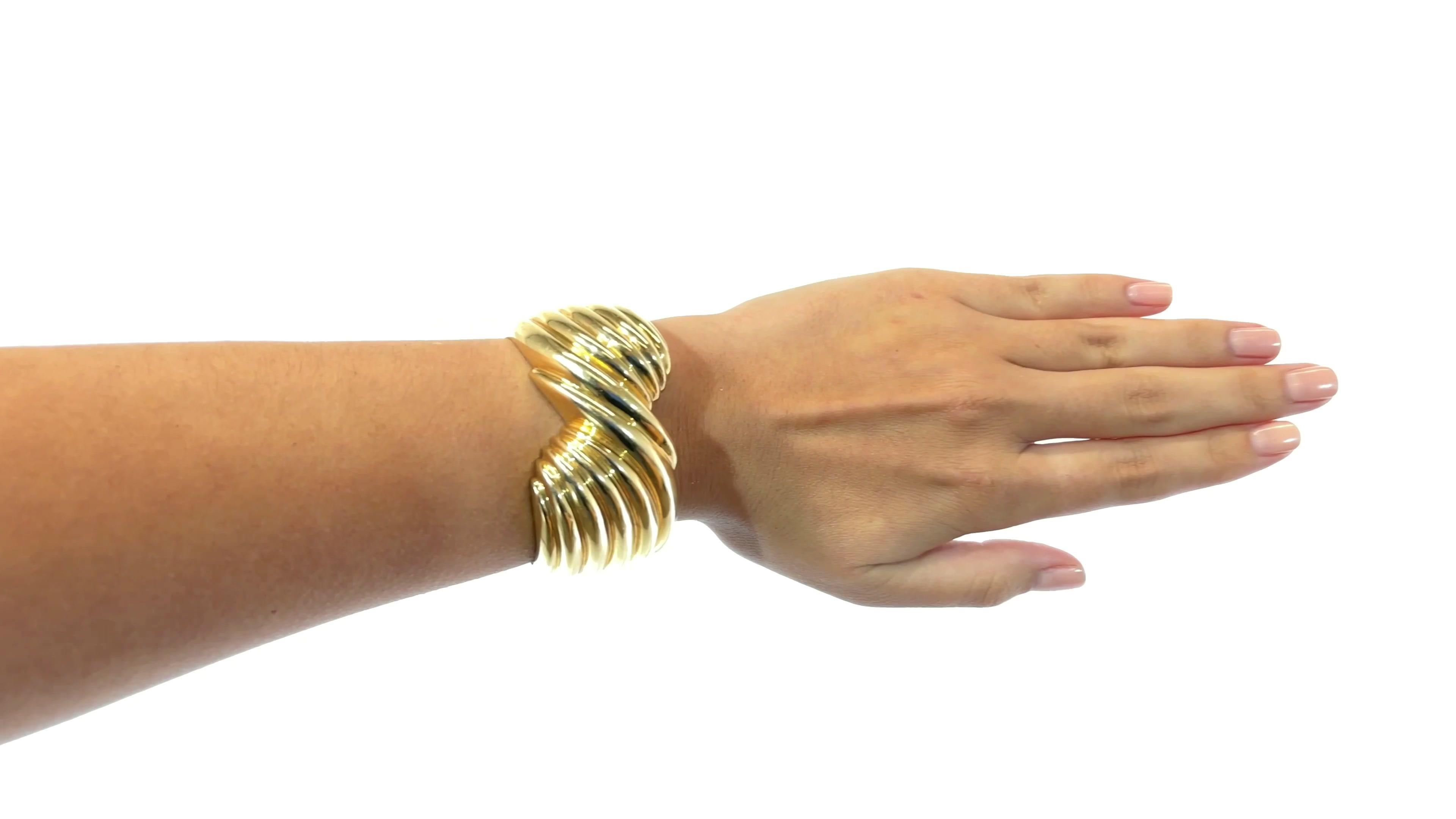 Vintage Gold Cuff Bracelet. 14k yellow gold. 77.6 grams. Circa 1980s.

About the piece: Interesting swirl designed gold bracelet. It's a very big look but easy to wear. Excellent with a black outfit for evening wear or with jeans for the farmer's