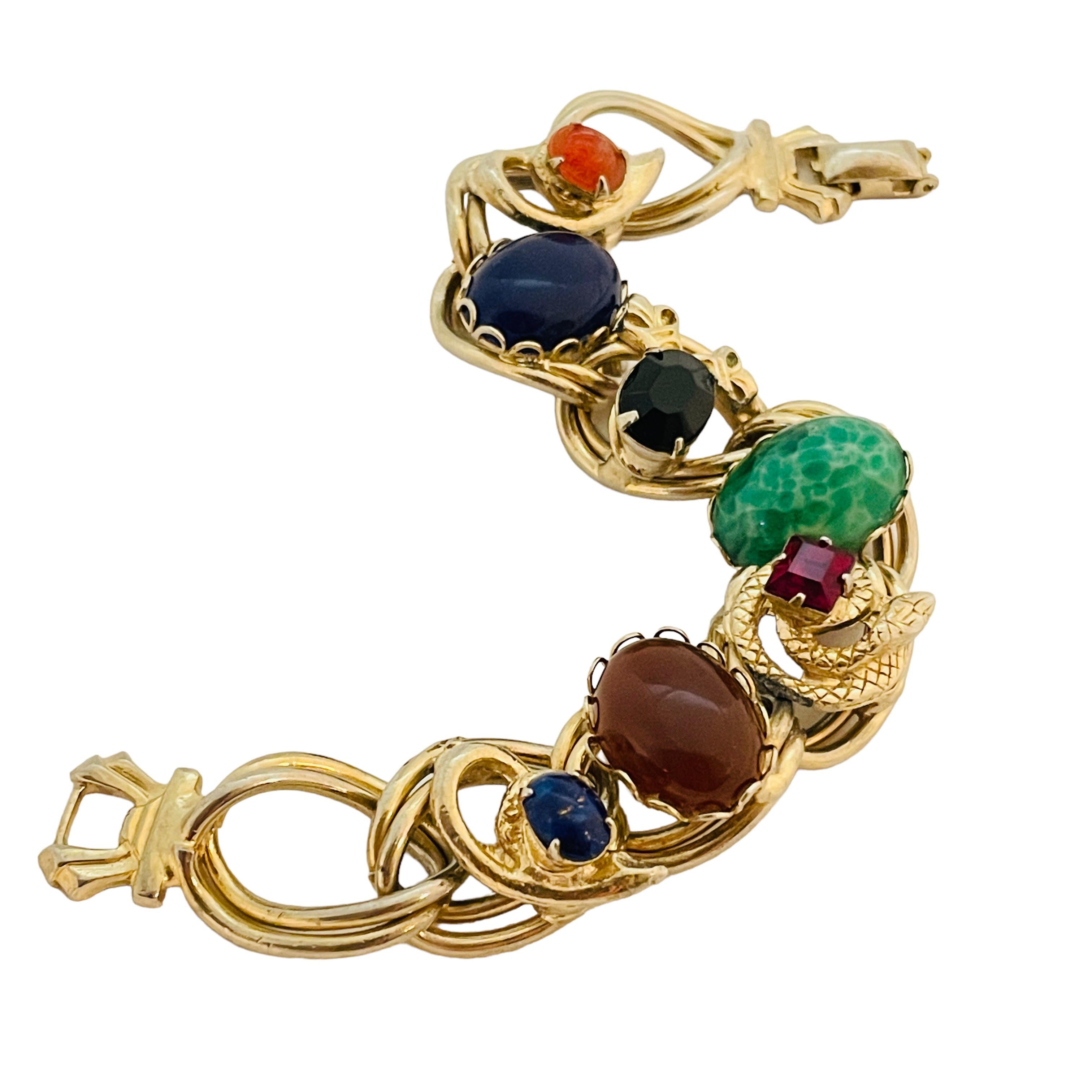 DETAILS

• unsigned 

• gold tone with glass stones

• vintage designer bracelet

MEASUREMENTS

• 7.55