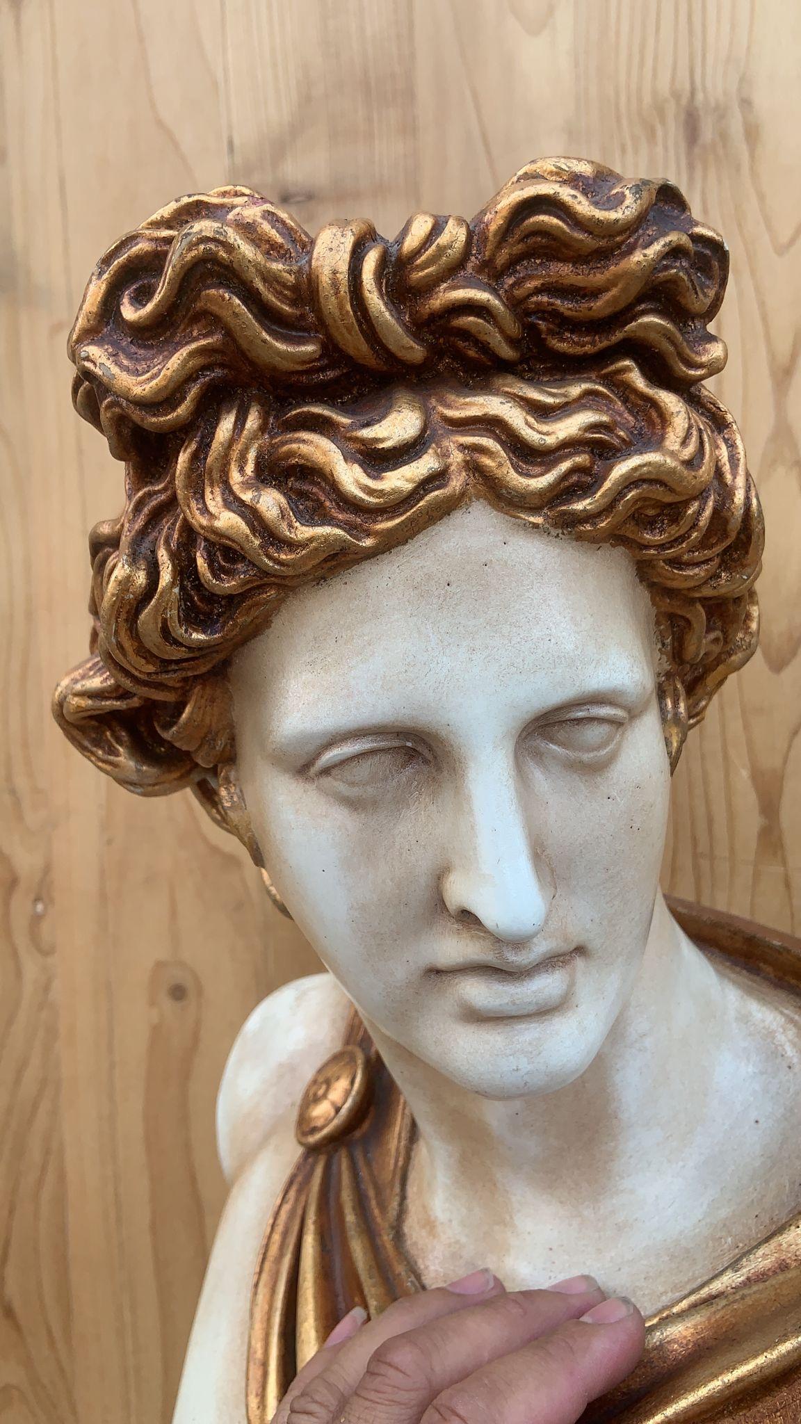 Vintage Gold Gilt Apollo Bust with Column Pedestal 

A Vintage Gold Gilt Apollo Bust with Column Pedestal is a stunning piece of classical-inspired decor that adds an air of grandeur and timeless beauty to any space. Here’s a description of such a
