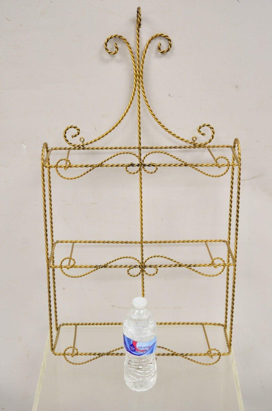 Vintage Gold Gilt Metal Hollywood Regency Scrolling Iron 3 Tier Small Wall Shelf with 3 Glass shelves. Circa Mid to Late 20th Century. Measurements: 28
