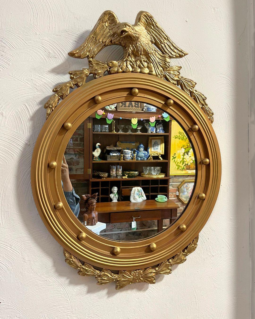 This 1970s Federal-style mirror features the iconic eagle perched atop, symbolizing American strength, with detailed acanthus leaves. Inherited by my client from her grandmother, it has been passed down through the family and is in great condition