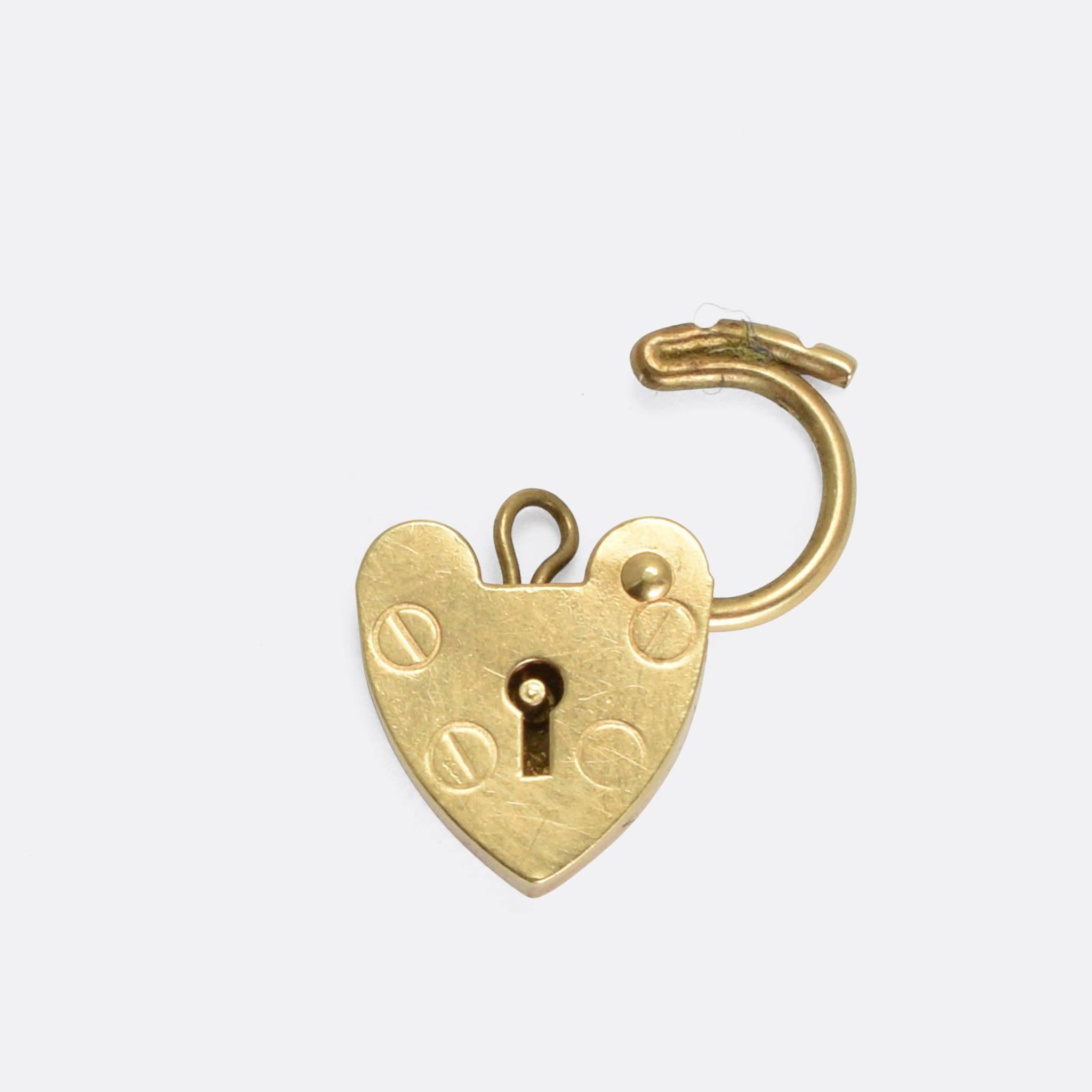 A sweet little heart padlock modelled in 9 karat yellow gold. It dates to the 1980s, with clear London hallmarks and the maker's mark ASJ. The top opens up, allowing easy attachment to a necklace chain or charm holder.

MEASUREMENTS
13.1 x