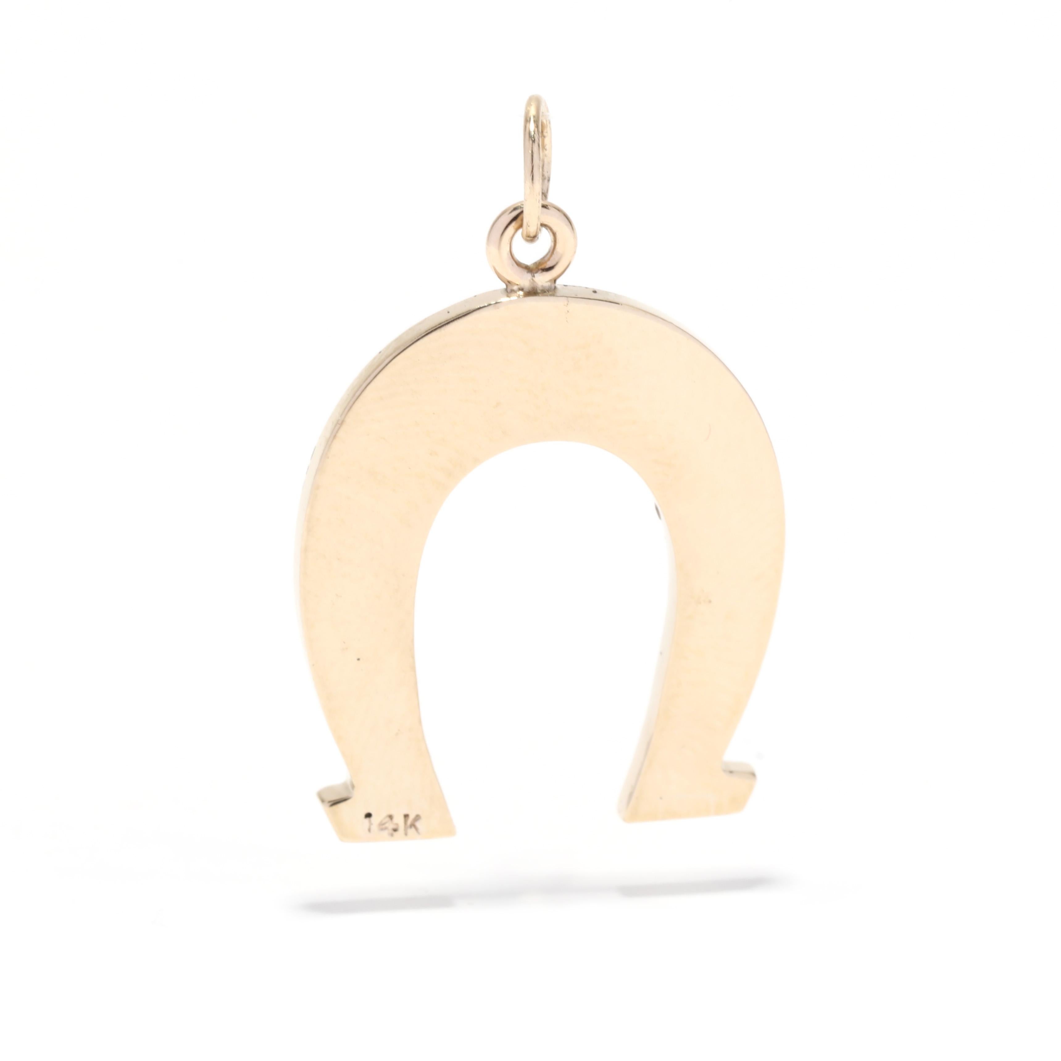 A vintage 14 karat yellow gold horseshoe charm. This large charm features a horseshoe motif with a textured finish and a polished border.

Length: 1 1/8 in.

Width: 3/4 in.

Weight: 2.6 dwts. / 4.04 grams

Stamps: 14K

Ring Sizings &