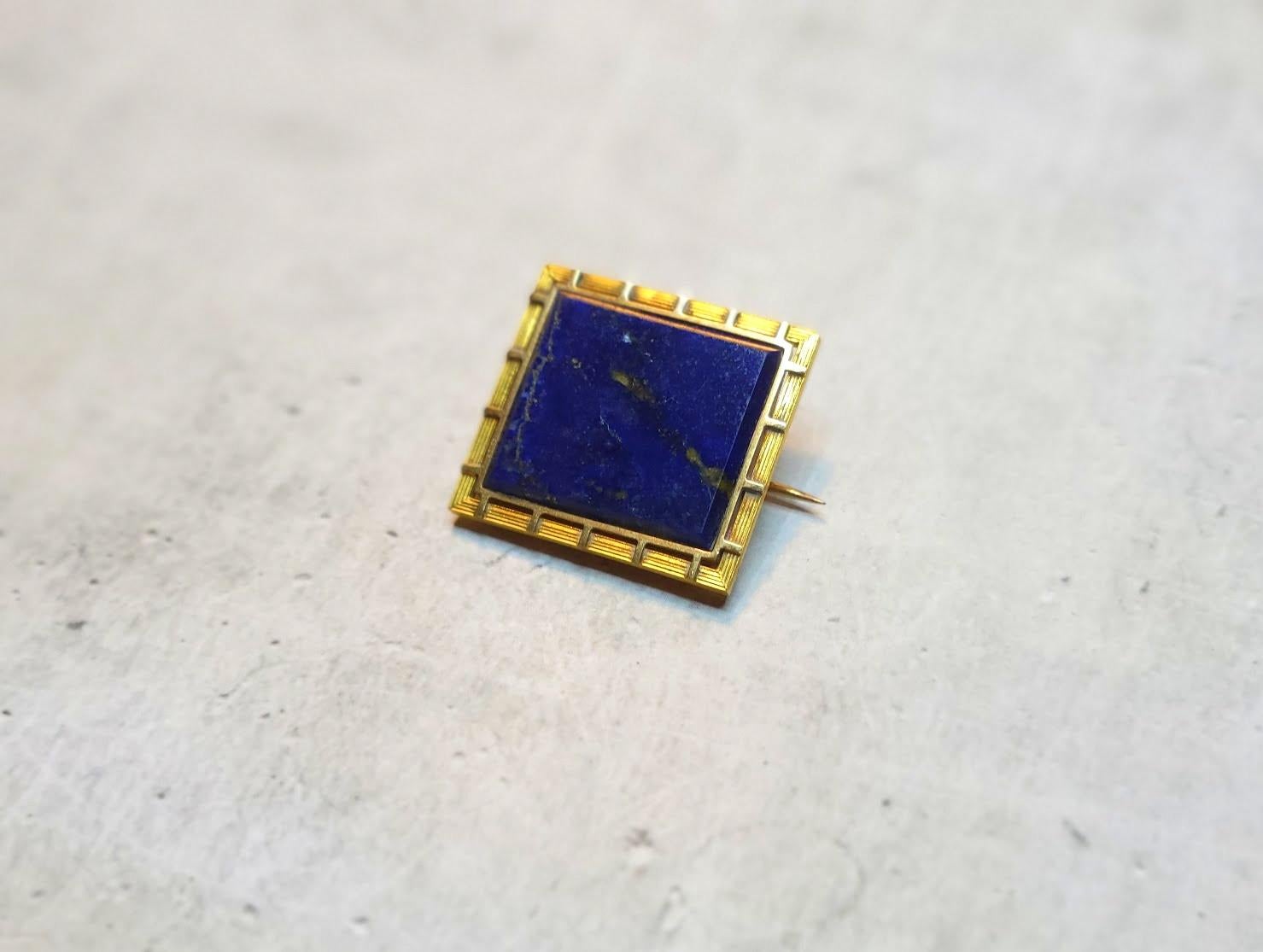 This vintage 9K gold brooch in Art Deco Style approx 1920-1930.

The brooch is approximately 23.8mm x 25.8mm.
Weight 5.5g
High quality dark blue lapis lazuli with gold pyrite.

On the back side of the brooch there are numbers: 1274 38. 
On the back