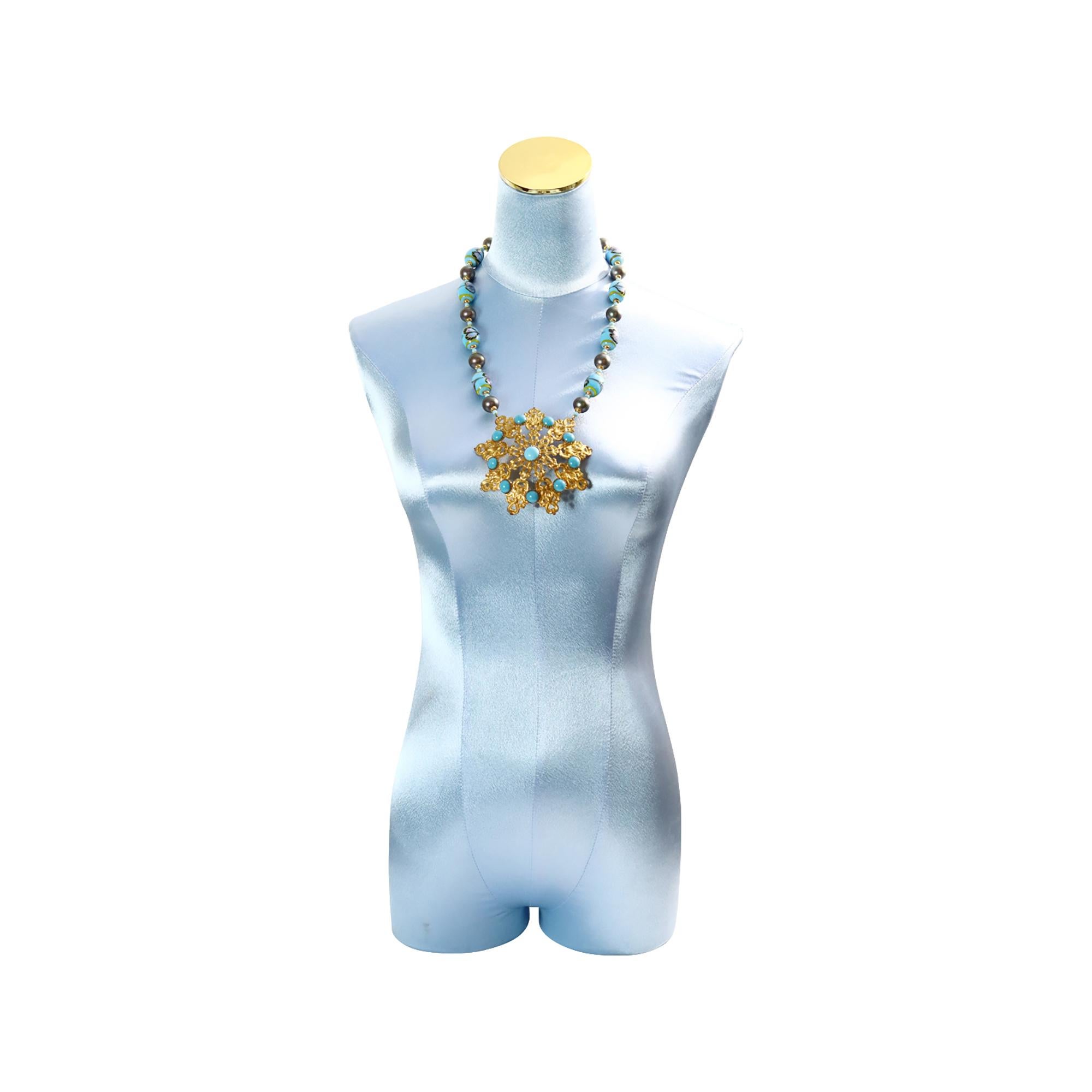 Vintage Gold Tone Large Disc with Faux Turquoise Glass Beads. It will look great on, as the colors go with many things. Acquired in Paris.  The necklace's length is 22 inches. The Total L is 29