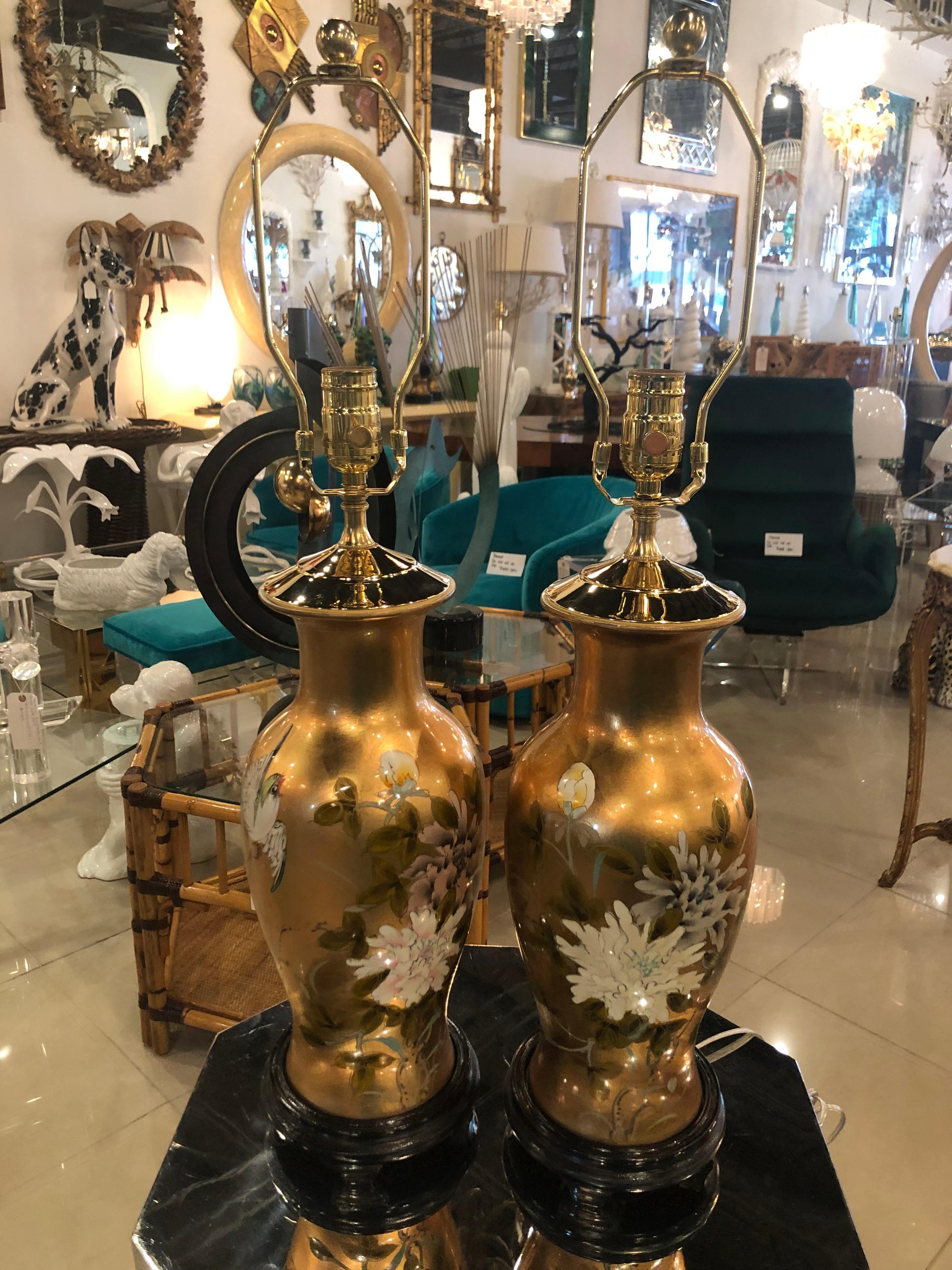 Lovely pair of vintage chinoiserie table lamps. Lovely gold leaf, birds, flowers, wood base, brass pagoda top. Newly wired and all new brass hardware. 
Height 27.5 finial
Height 20.5 to socket.