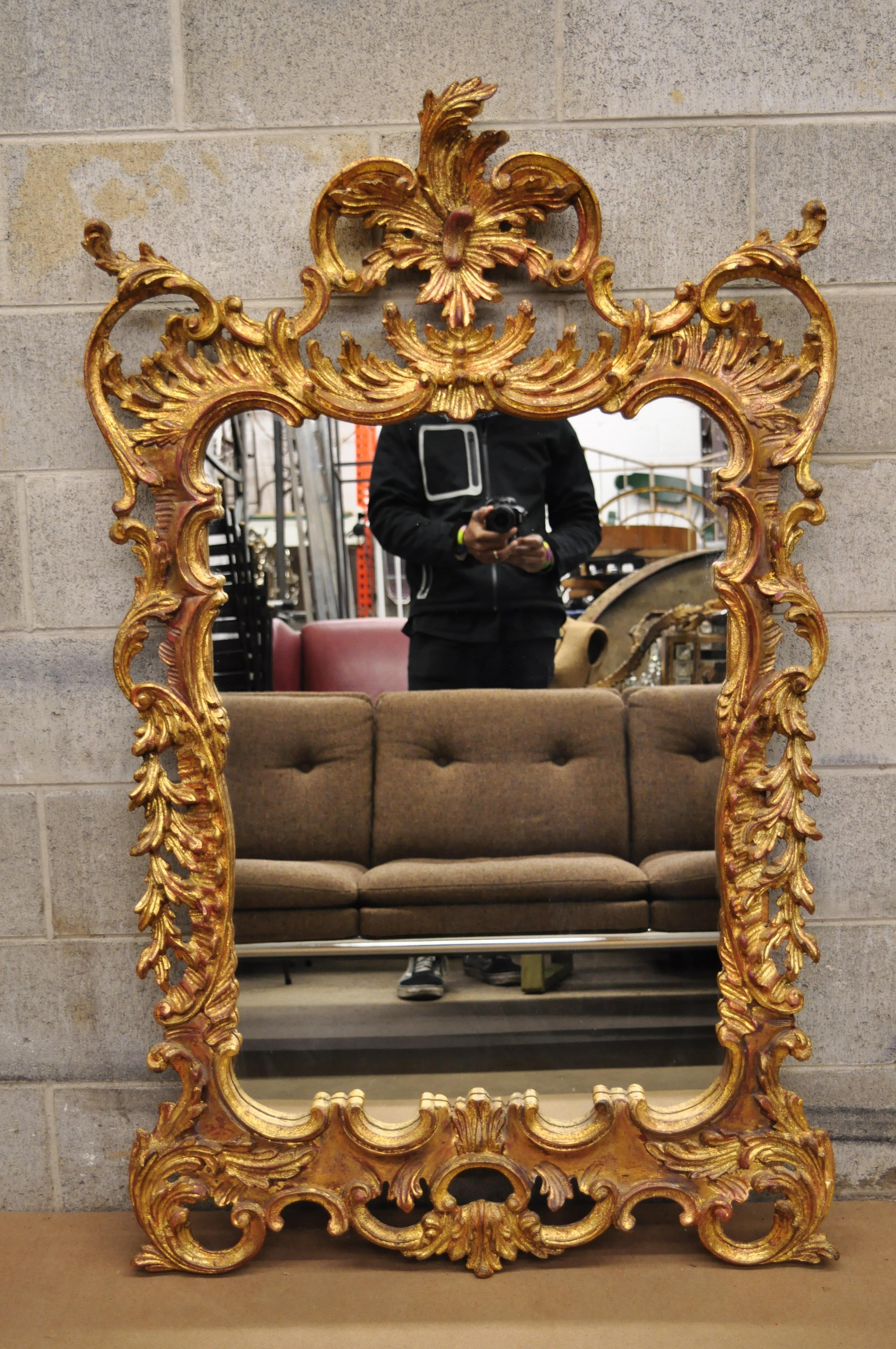 Vintage gold leaf French Louis XV Rococo style console wall mirror. Item features ornate pierce cared frame, gold leaf finish, great style and form, circa late 20th century. Measures: 57