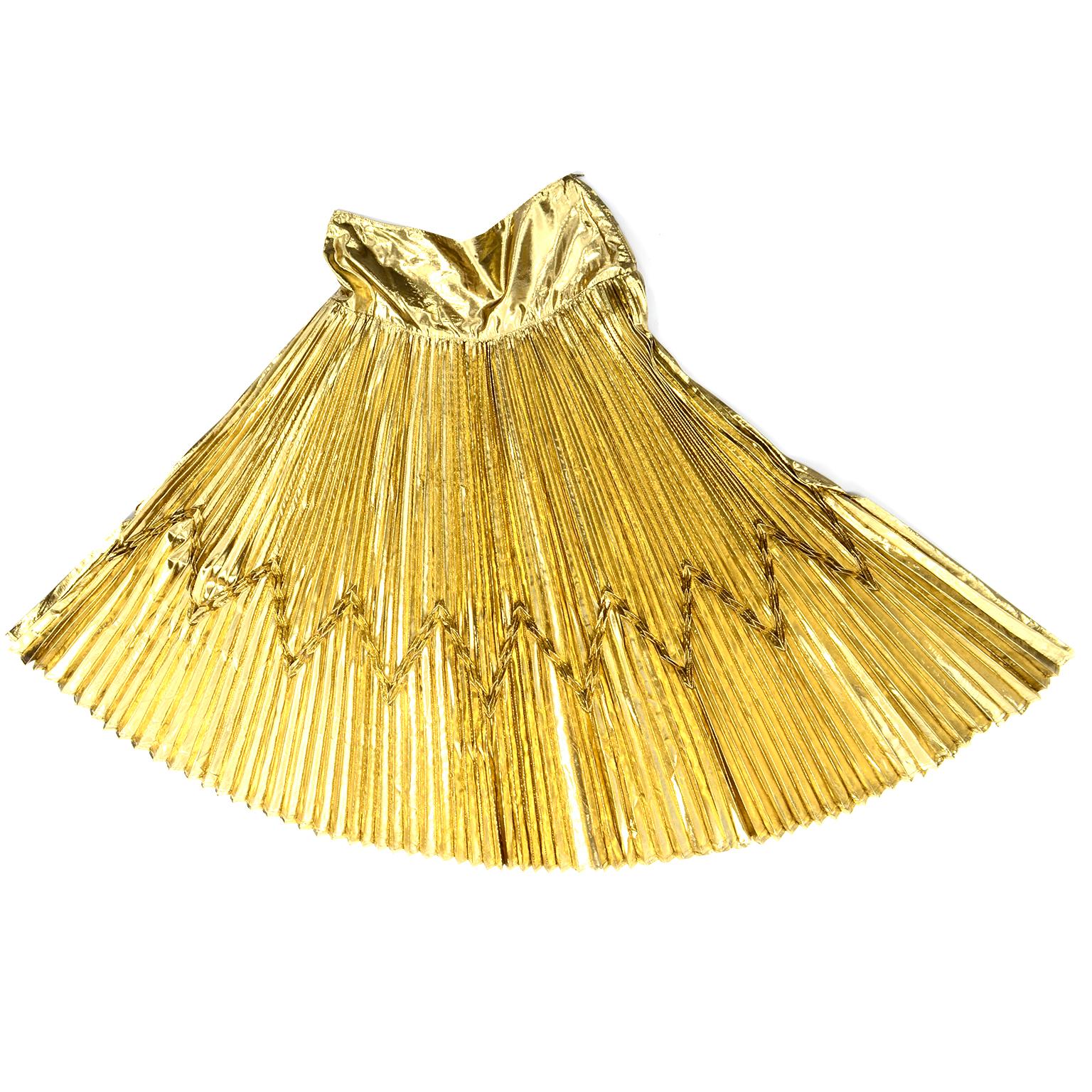 This is a truly stunning vintage gold lurex 1990's Gianni Versace for Genny accordion pleated skirt. We love the unique raised details that form a chevron pattern along the pleating. This could be worn with so many pieces you already have in your