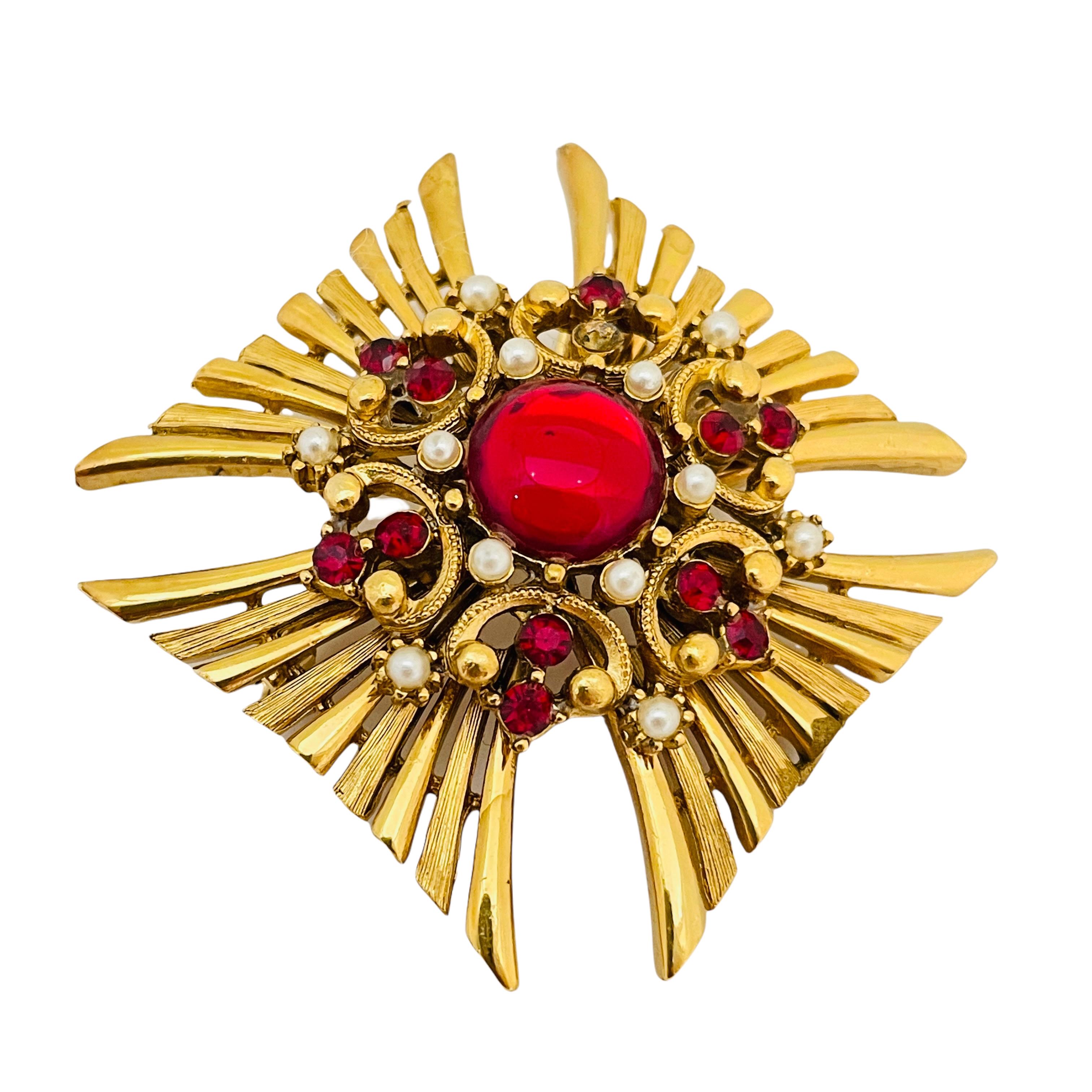 red and gold brooch