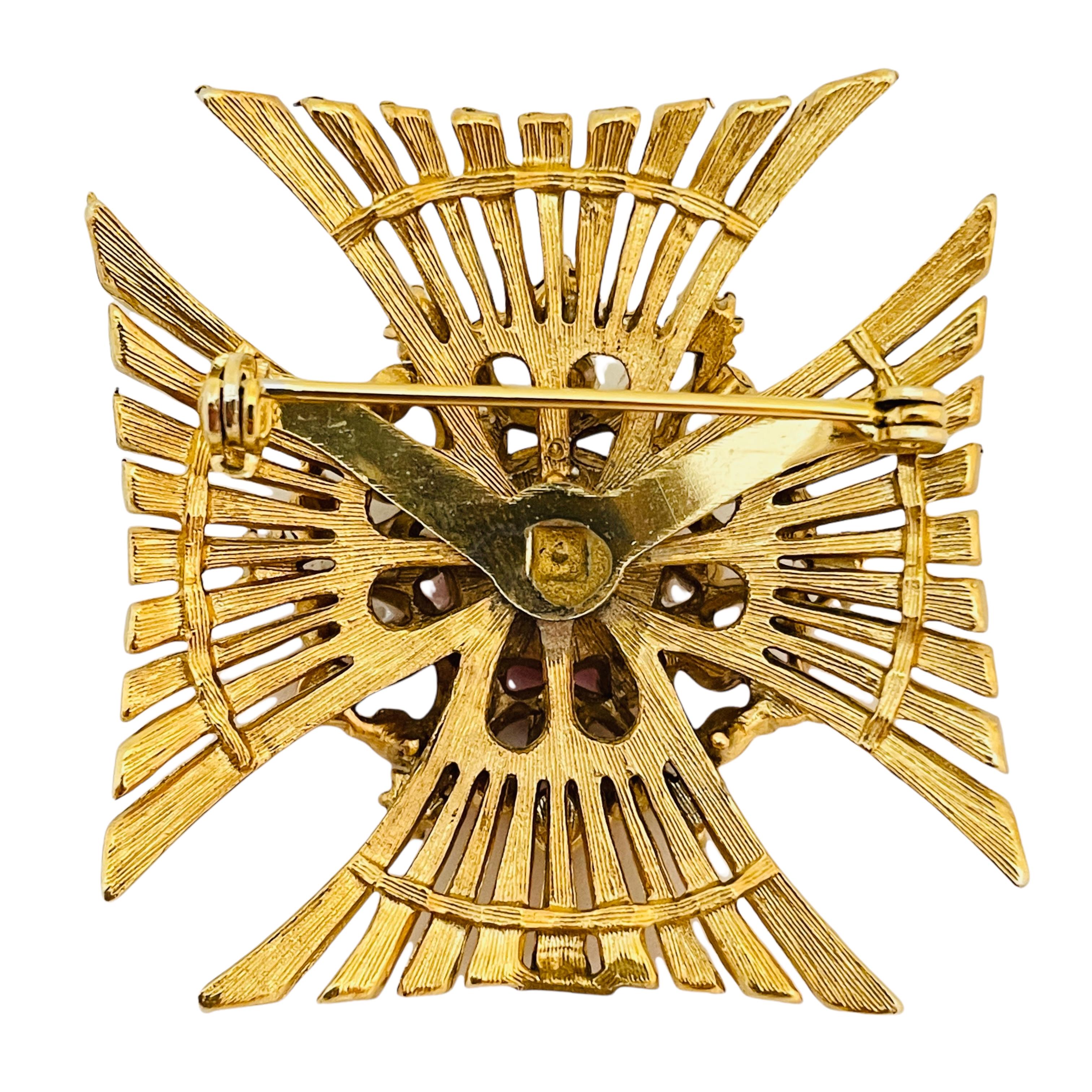 red and gold brooch