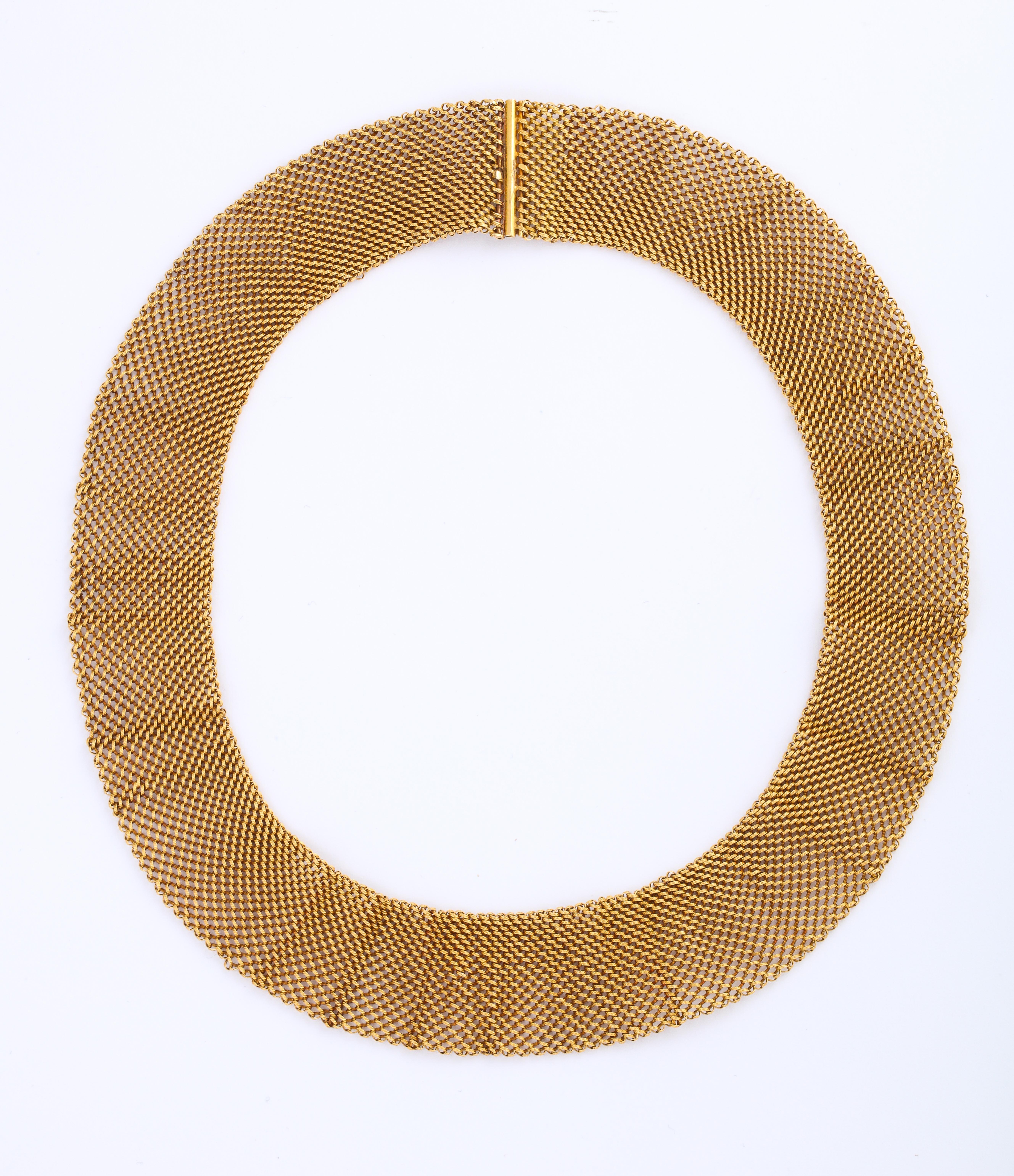 A stunning  Gold Mesh Collar in 14 k gold  which is soft and flexible and easy  to lay around the neck 
You can add a clip or interesting brooch. as an art piece.
Everyday wearable.