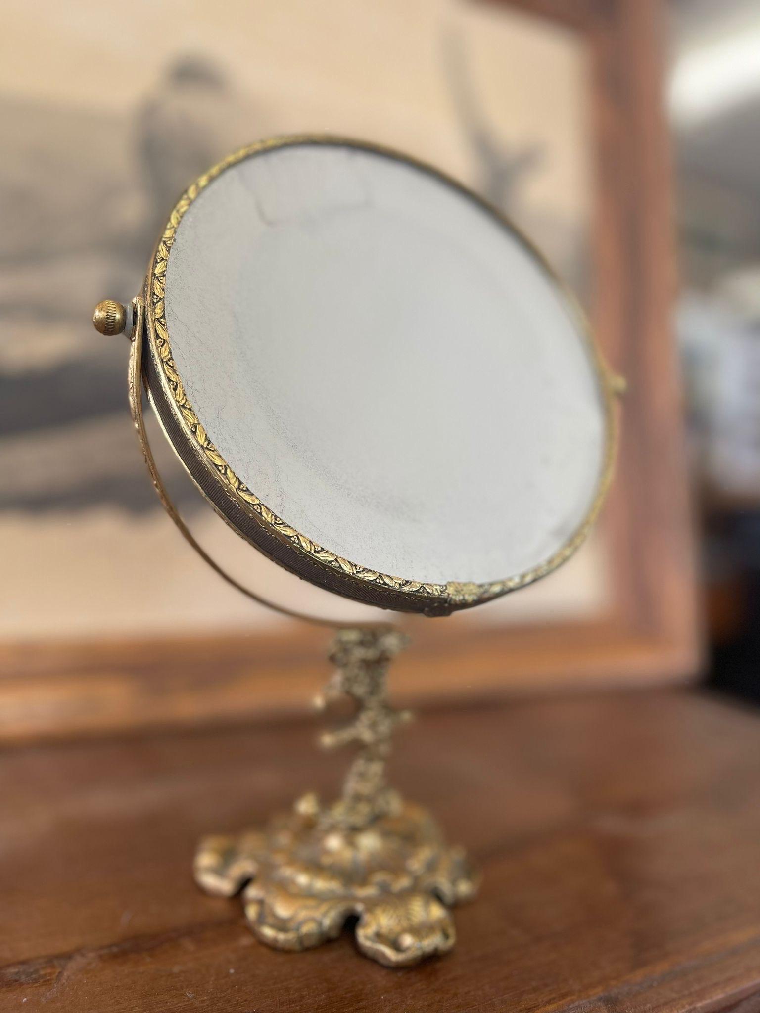 Vintage Gold Mirror With Detailed Base. Antique Style Patina Glass Consistent with Age

Dimensions. 6 W ; 4 D ; 10 H