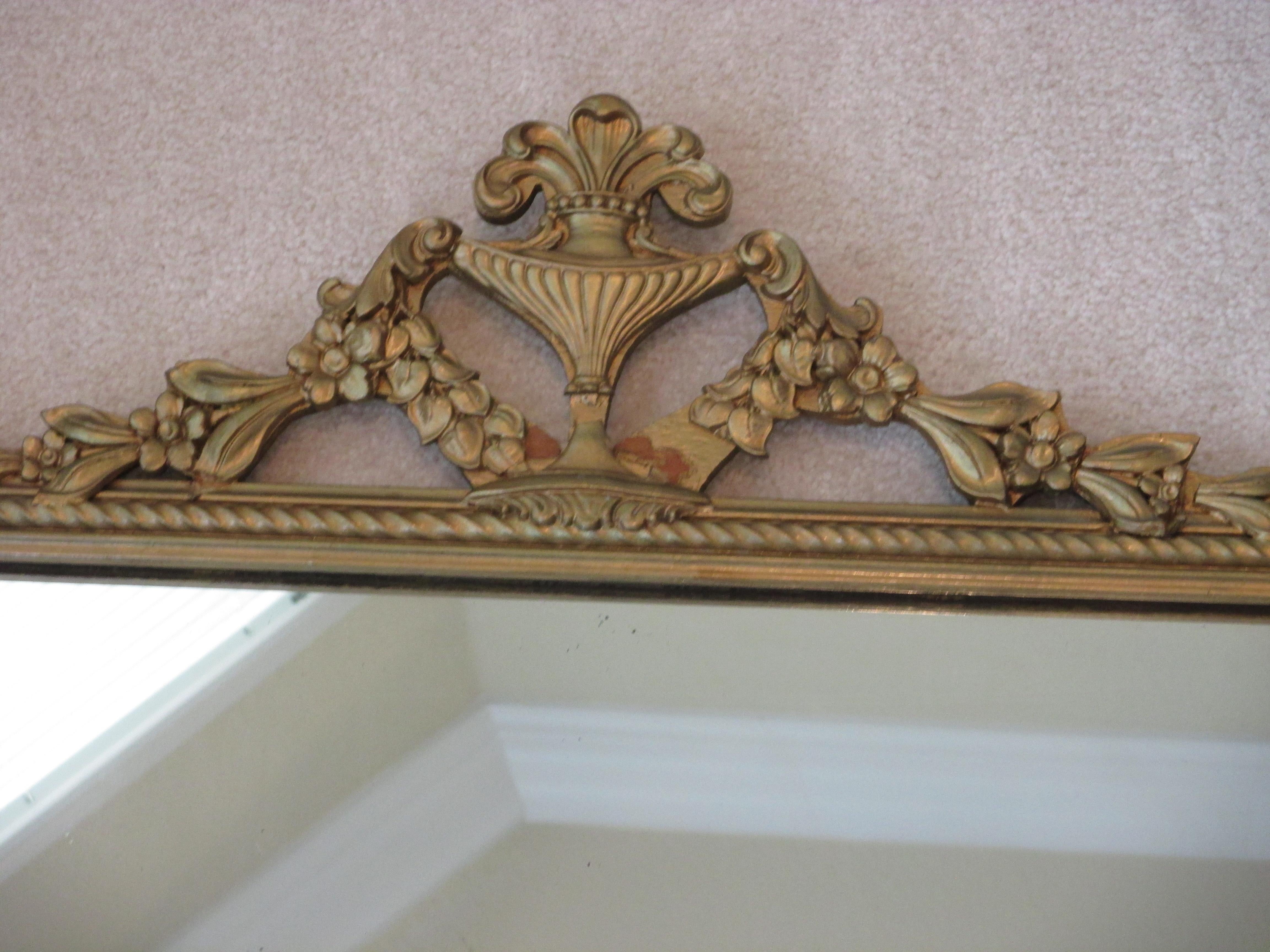 Beautiful vintage gold wooden mirror with ornate trim. Hanging hardware is attached.