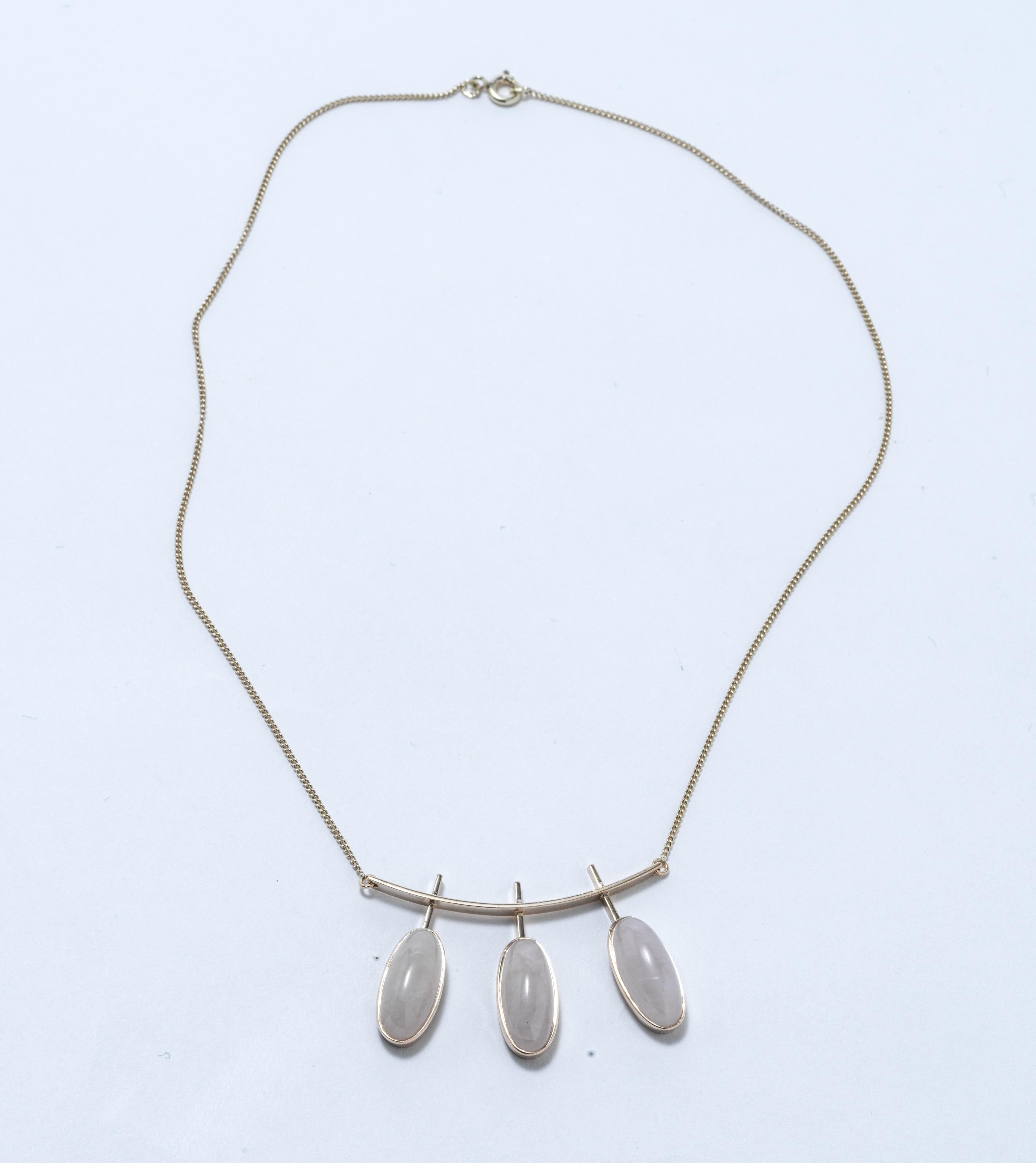 A charming gold necklace made in 1959 by the Finnish goldsmith master Eero Eskelinen. It is made of 14 k gold with three oval cut milk quartz stones set in gold frames.  The design is light and has an airy feeling to it. This is a necklace you can