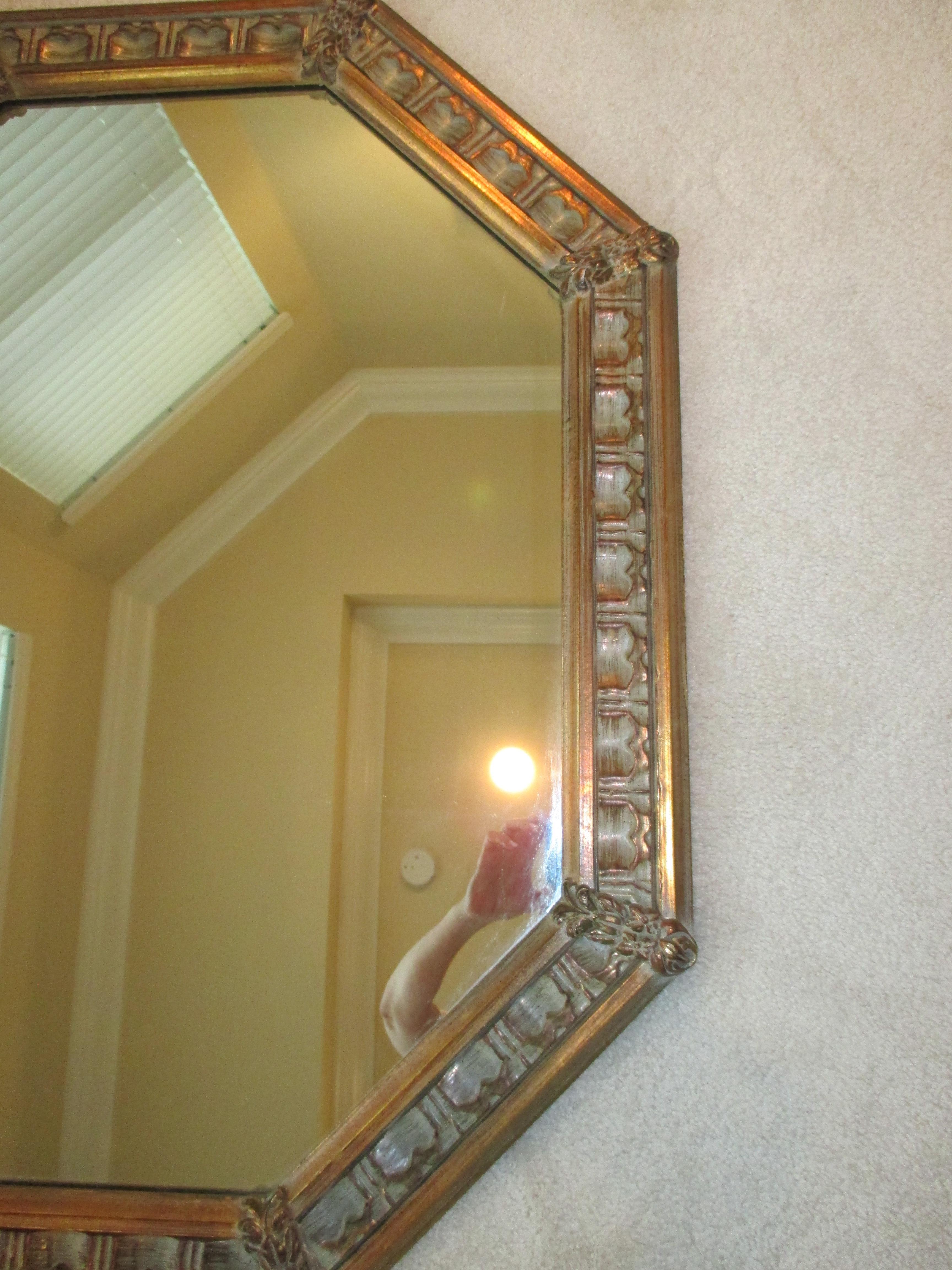 Beautiful gold wooden octagonal mirror with floral accents. Hanging hardware is attached.
 