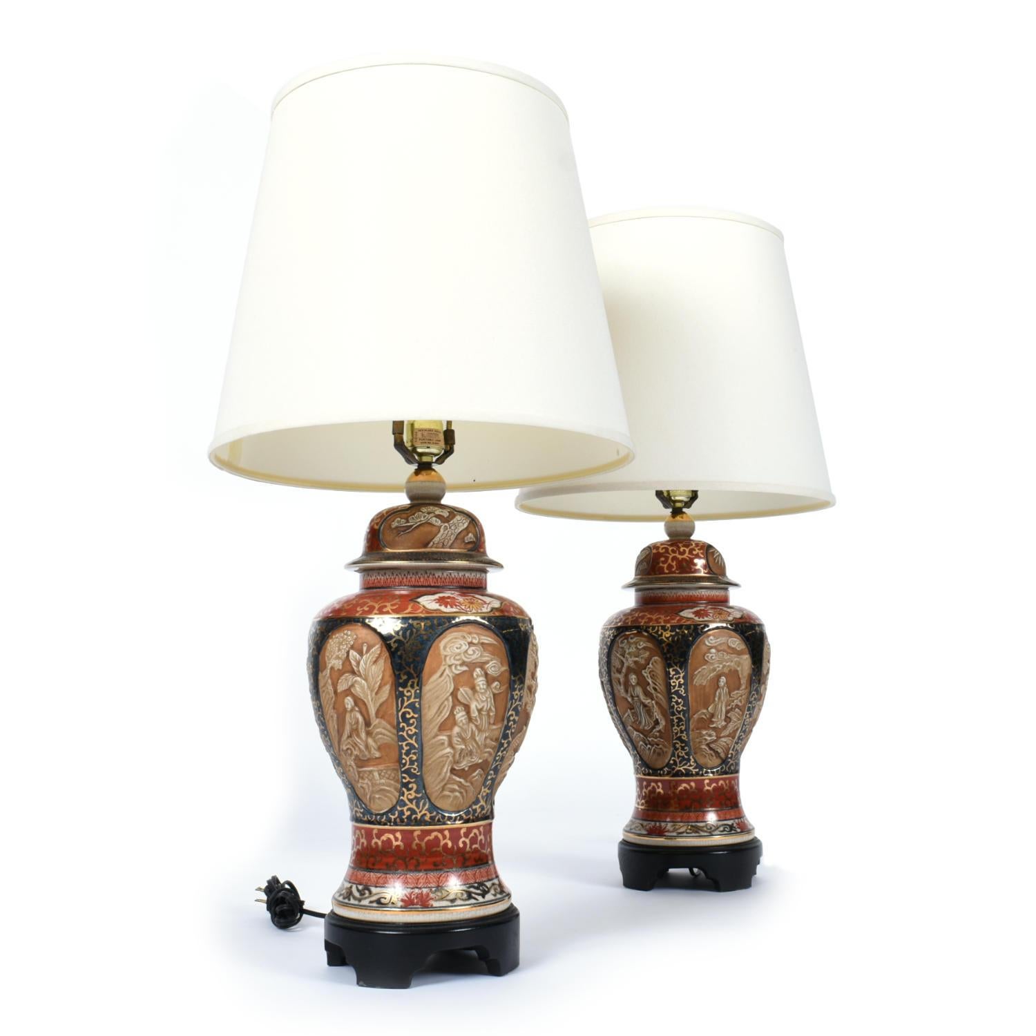The shades pictured are NOT INCLUDED with purchase. Shade dimensions below are for purpose of scale. 

Pair of vintage gold embellished porcelain Chinese lamps with elaborately adorned surfaces. The glazed lamps feature elaborate detail throughout