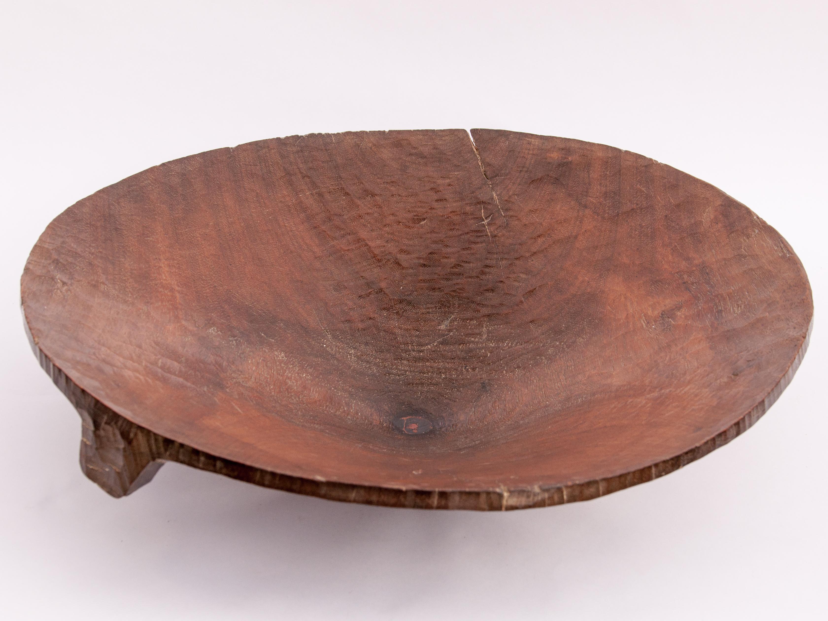 Vintage gold panning tray / bowl with added wooden base for stability. 23 inch diameter by 7 inches tall from Northeast Thailand, mid-20th century.
This rustic tray was fashioned from a single piece of local hardwood and used to pan for gold in the